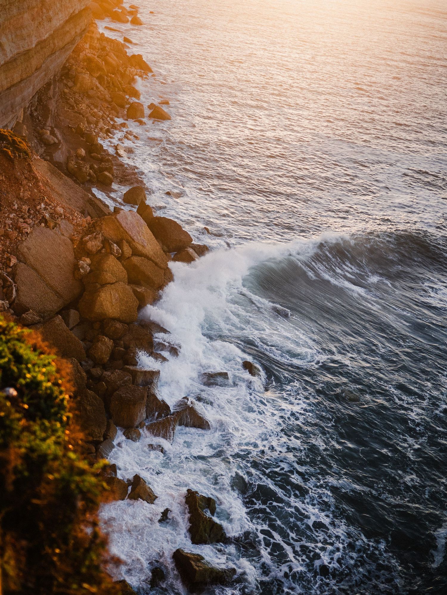 Waves of orange. Sunrise waves at Nazare, Portugal during Autumn 2023. © Jack Curtis Photography.