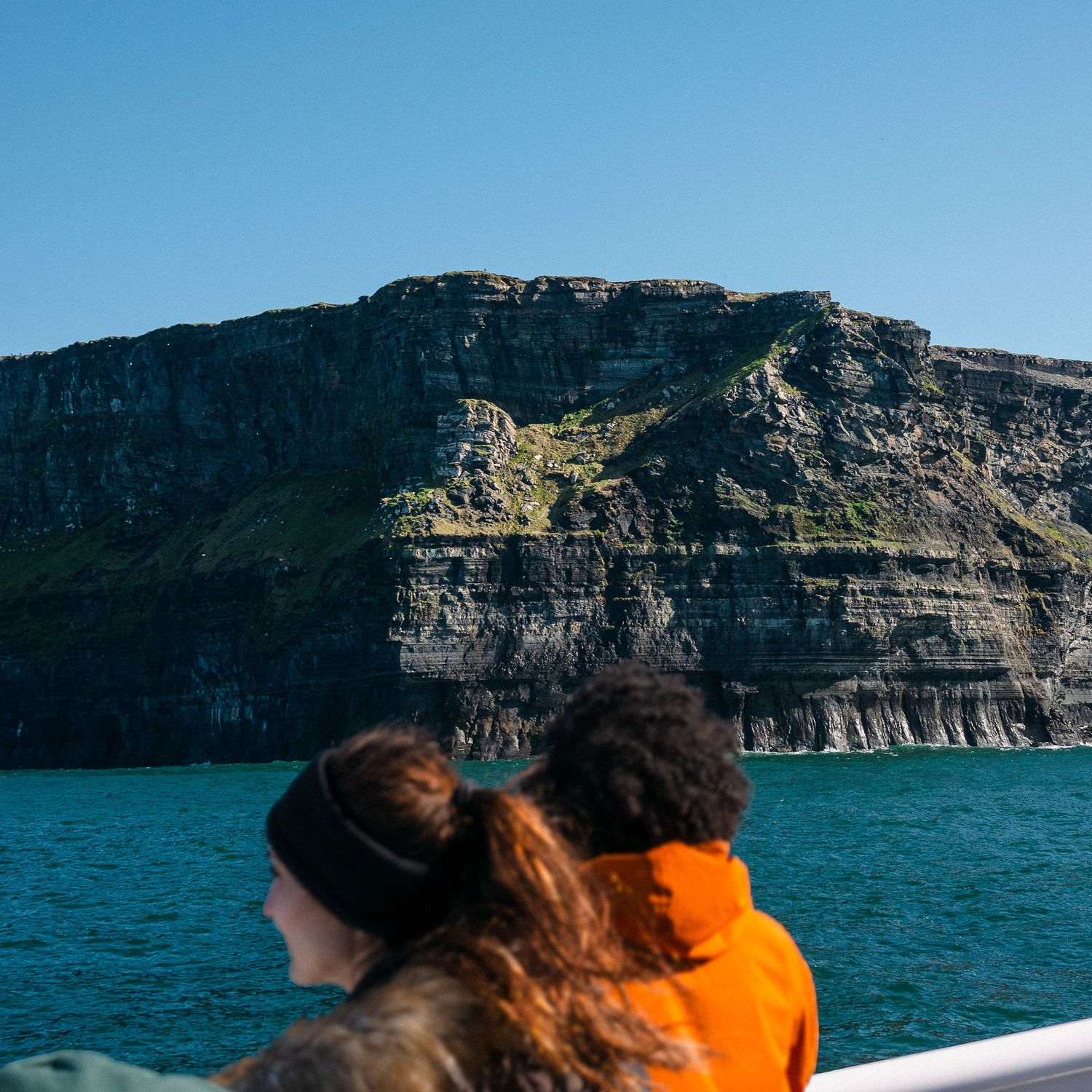A couple in awe on a tour boat by the Cliffs of Moore, Ireland during the Spring of 2024. © Jack Curtis Photography.