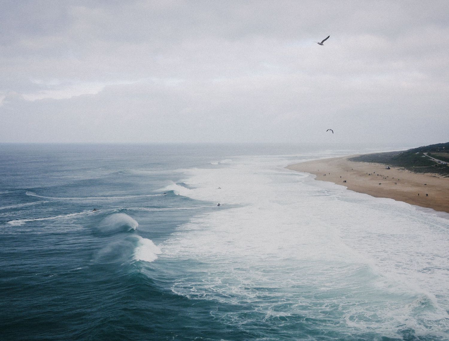 Rolling waves of a monster surf. Surfers at Nazare, Portugal during Autumn 2023. © Jack Curtis Photography.
