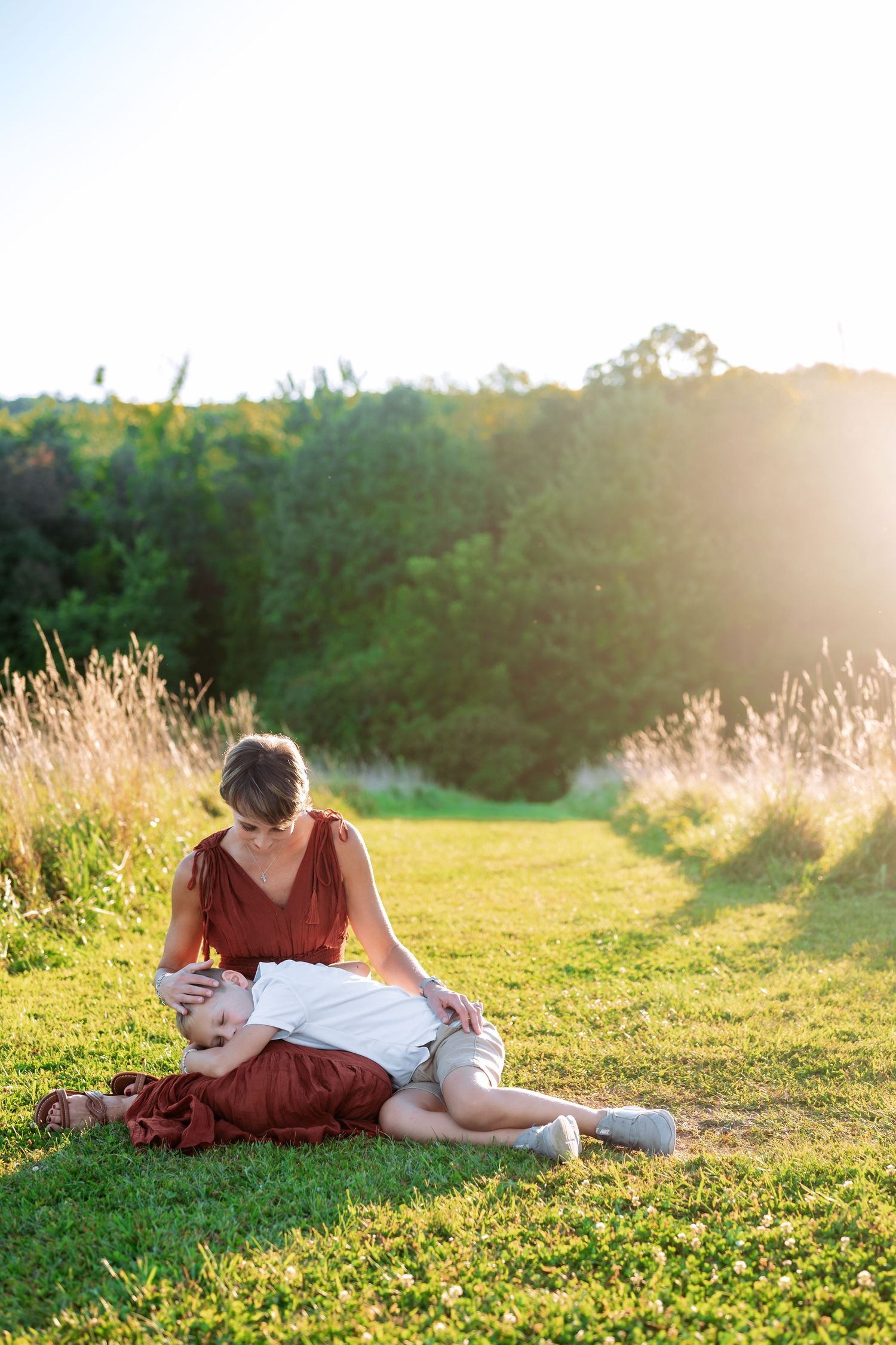 A sunset portrait session in a field of wildflowers and tall grass.
