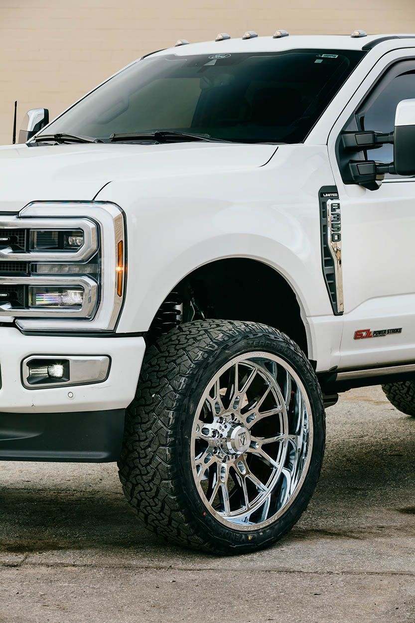 CROPPED IMAGE OF FORD F350 PICKUP TRUCK SHOWING NEW OFF ROAD WHEELS