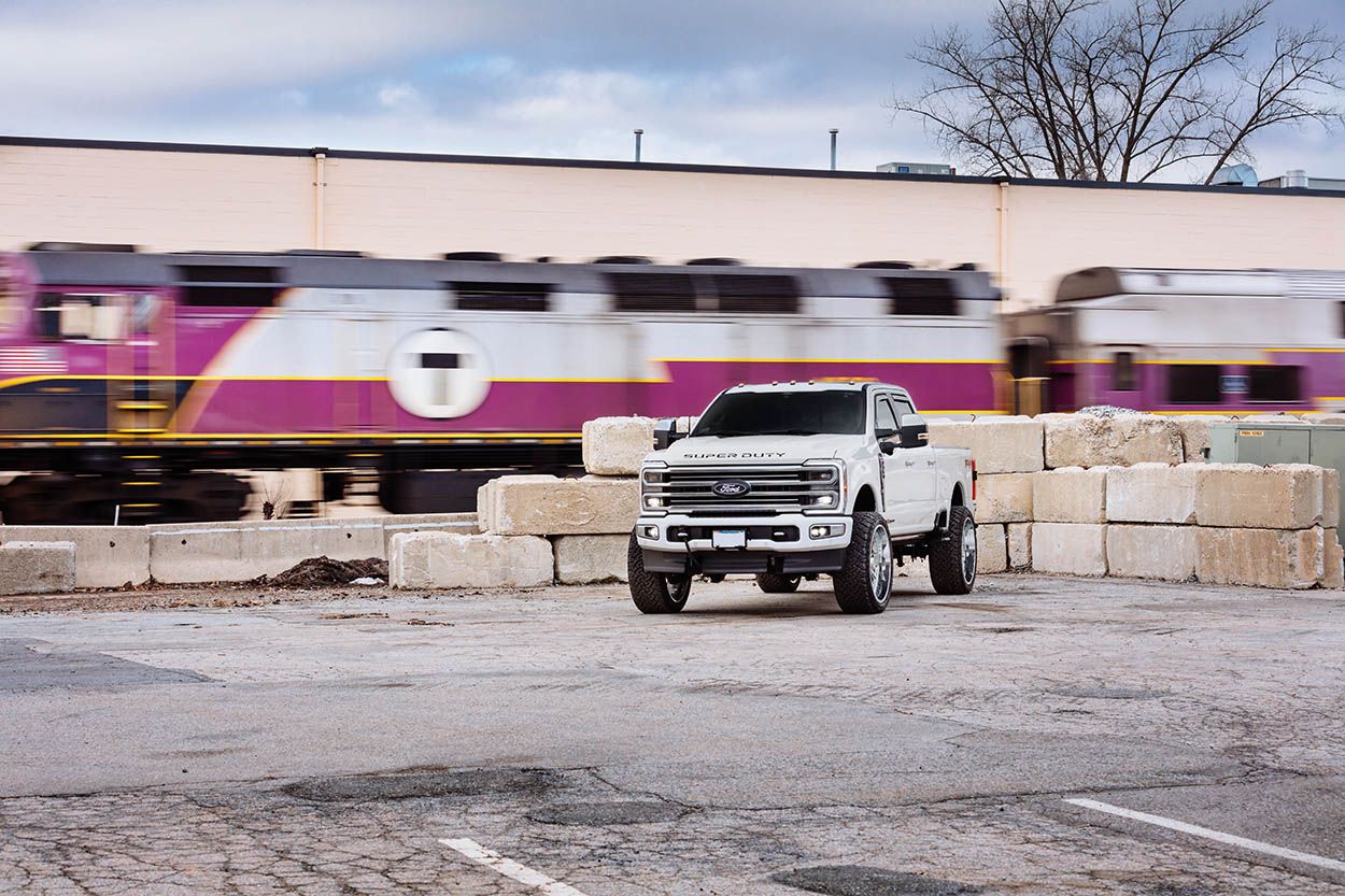 BOSTON CAR PHOTOSHOOT FORD F350 PARKING LOT WITH TRAIN PASSING IN THE BACKGROUND