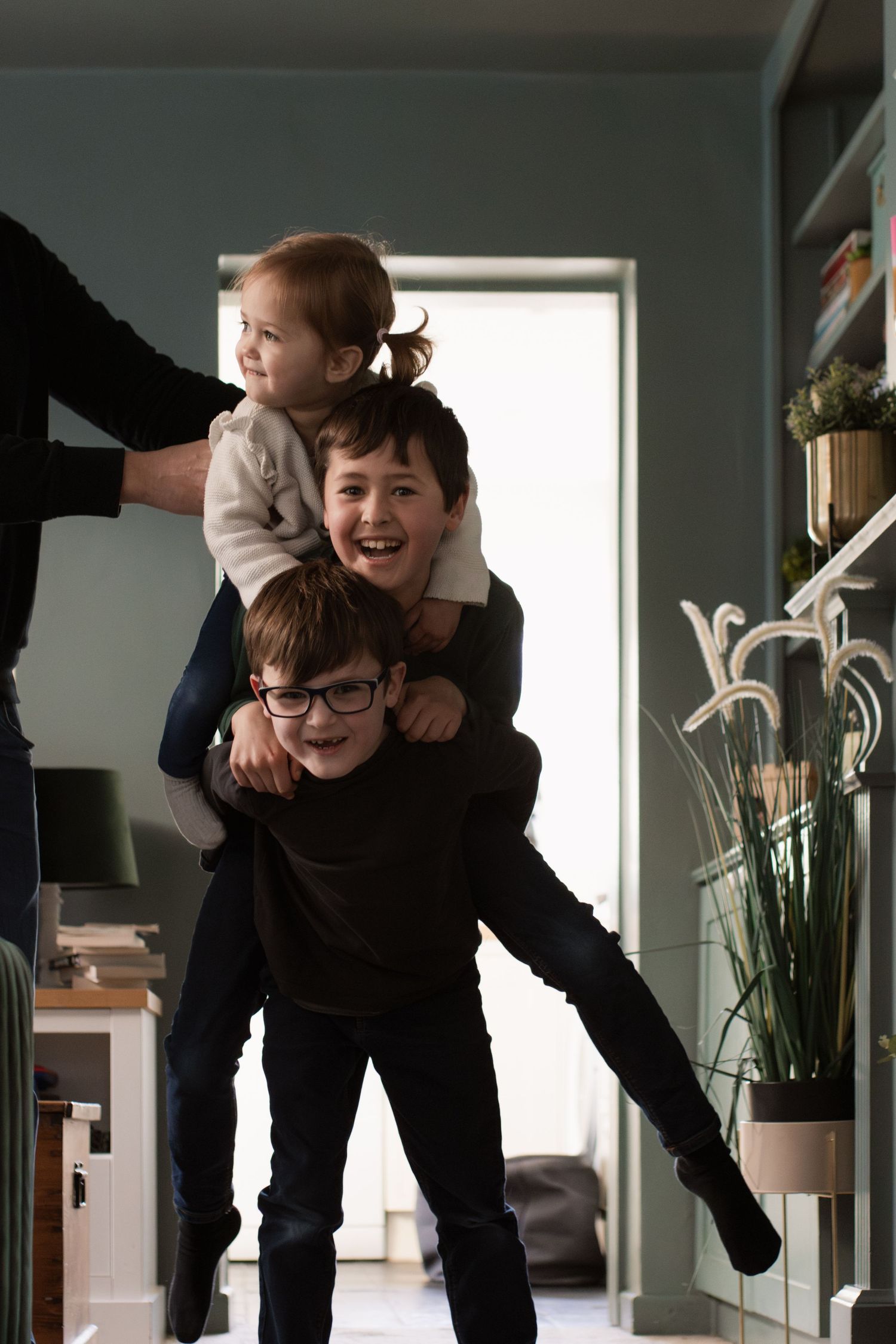 Playful sequence of movement captured in interior room with green walls.