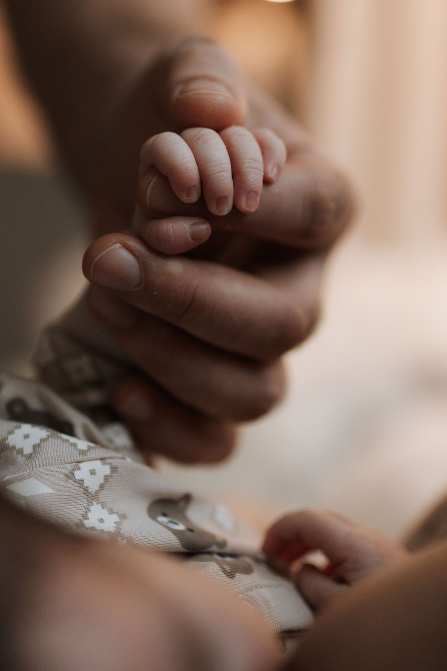 Close-up of tiny baby toes and feet against textured white fabric.