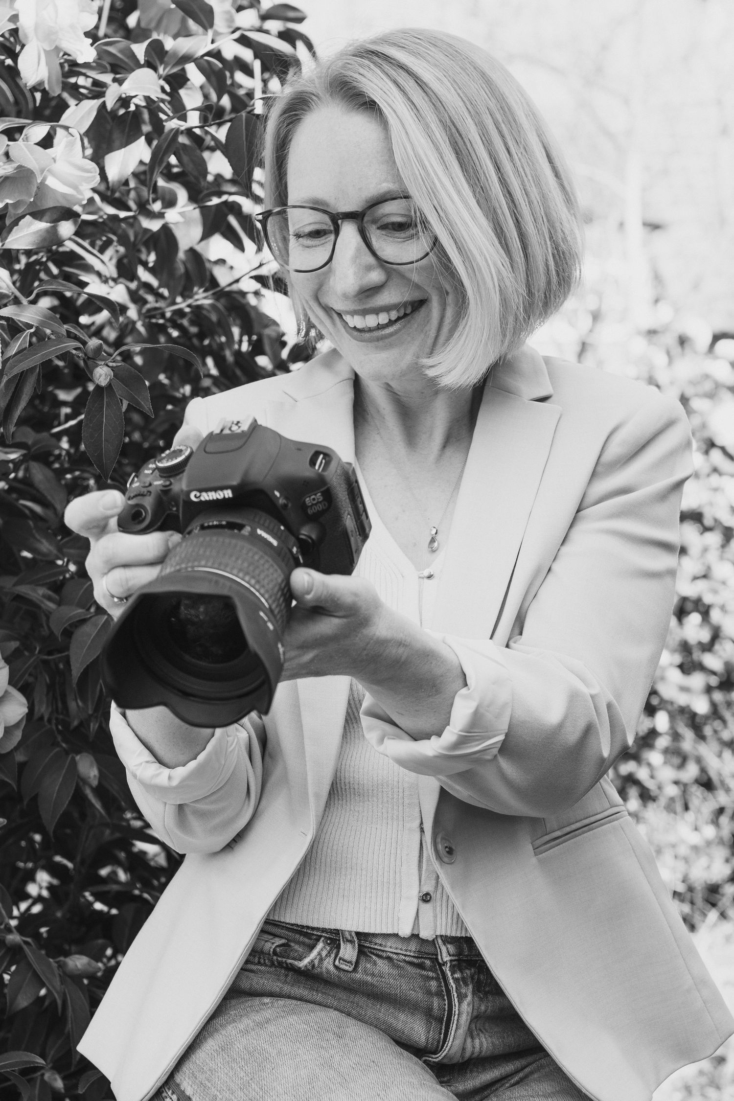 Black and white series showing photographer with camera in various poses against foliage.