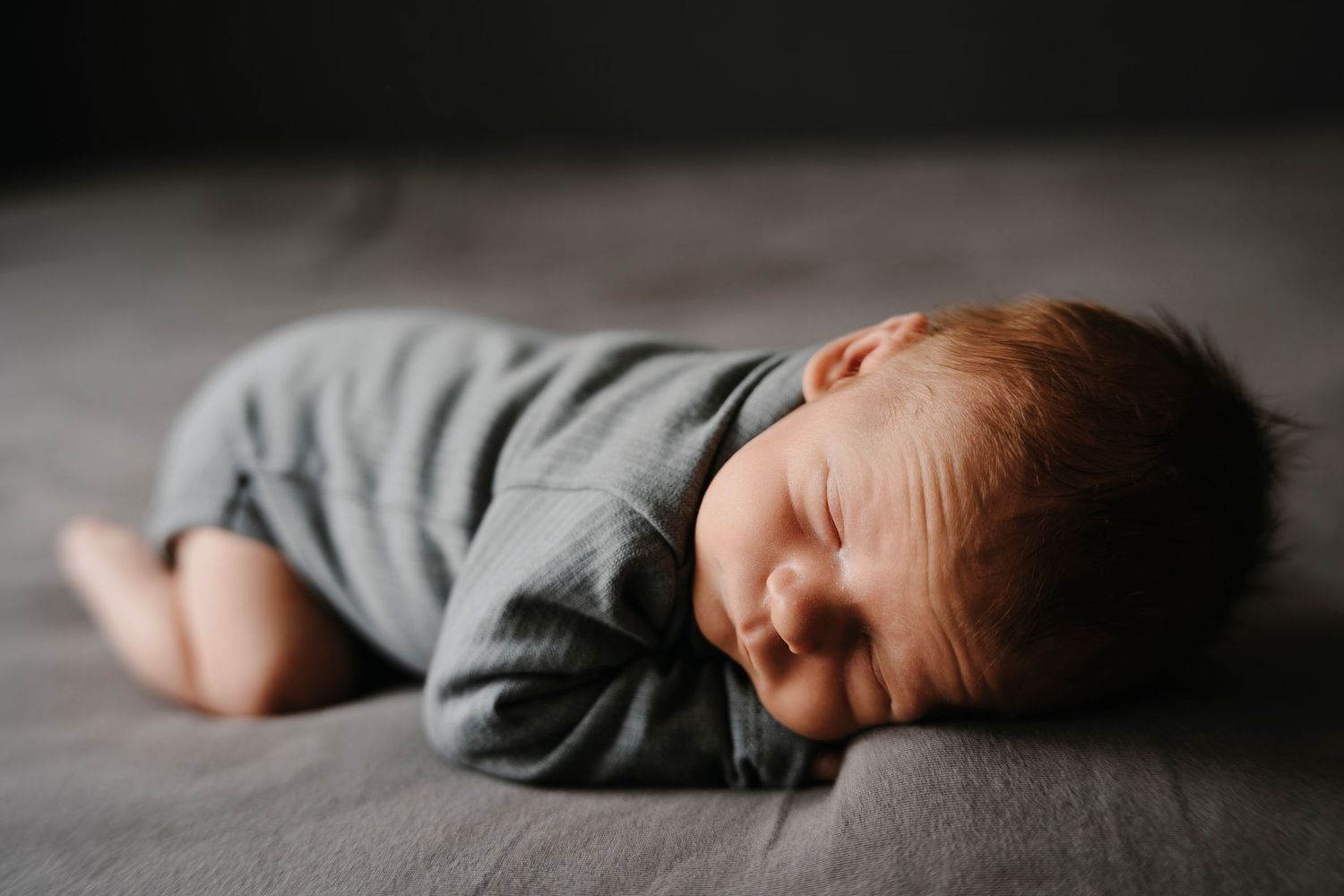Soft portrait series showing someone peacefully resting on a dark background, creating a calming mood.