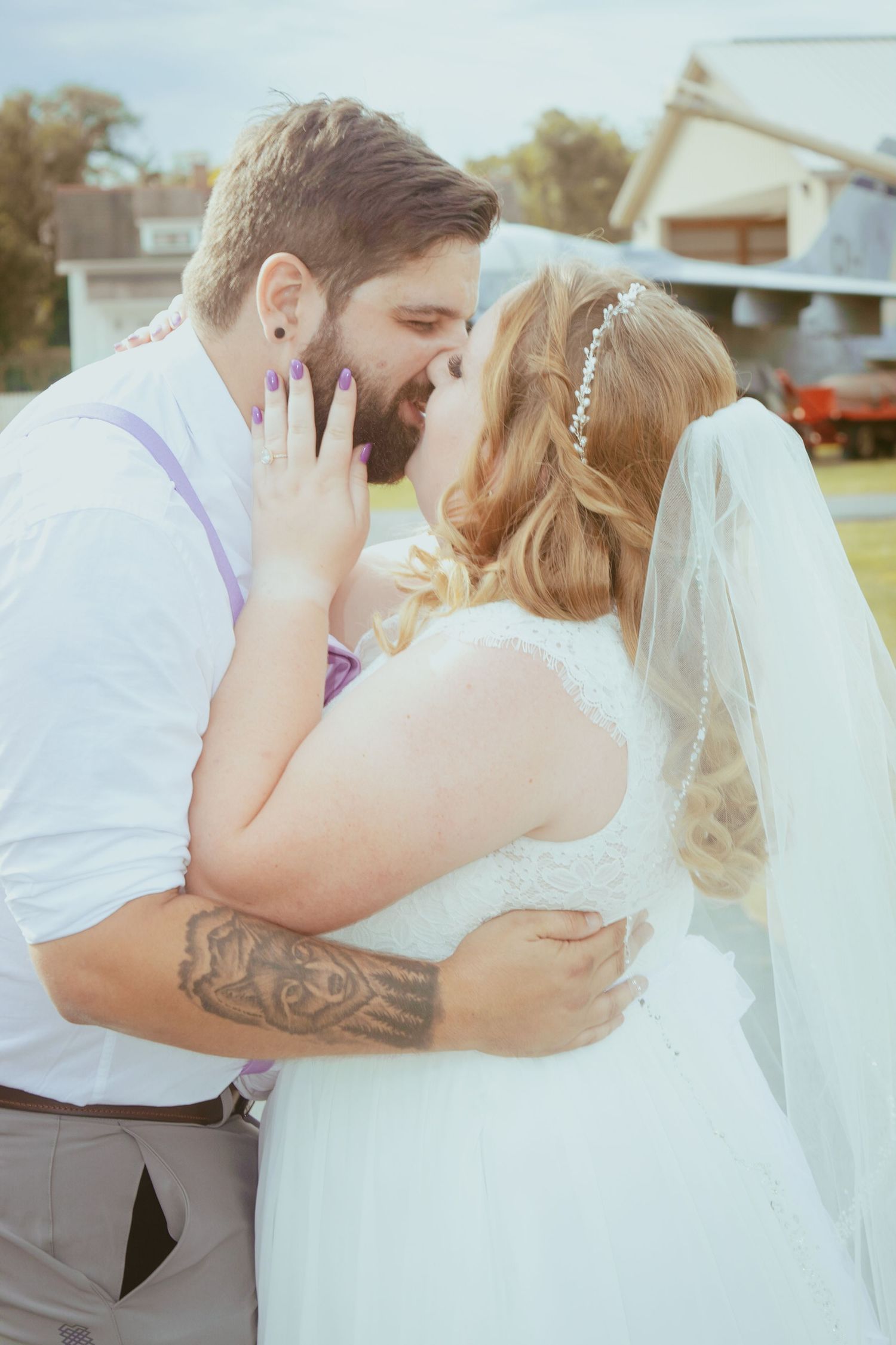 Romantic wedding couple sharing tender moments during their outdoor photo session.