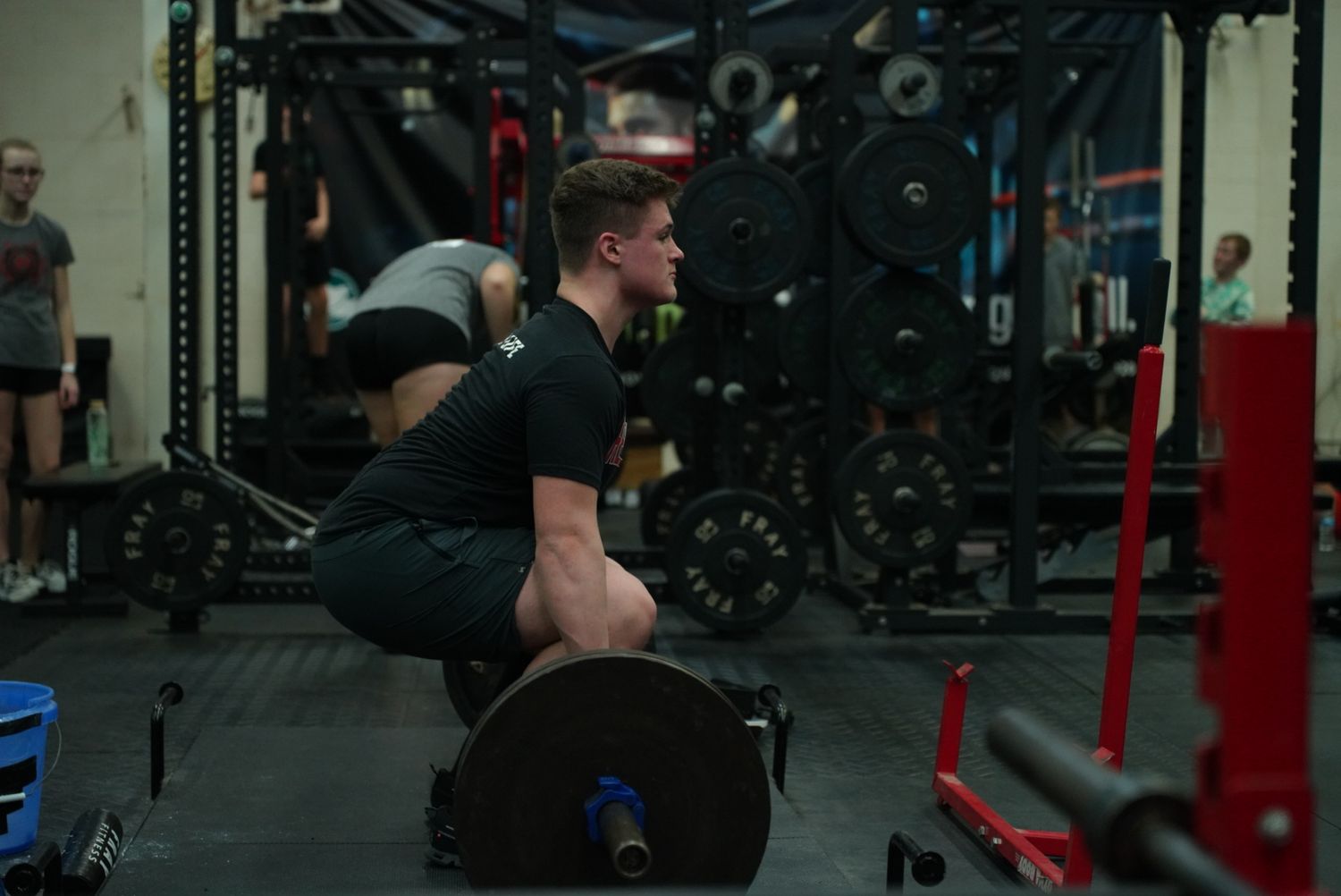 Athletes working out with equipment in a modern fitness facility.