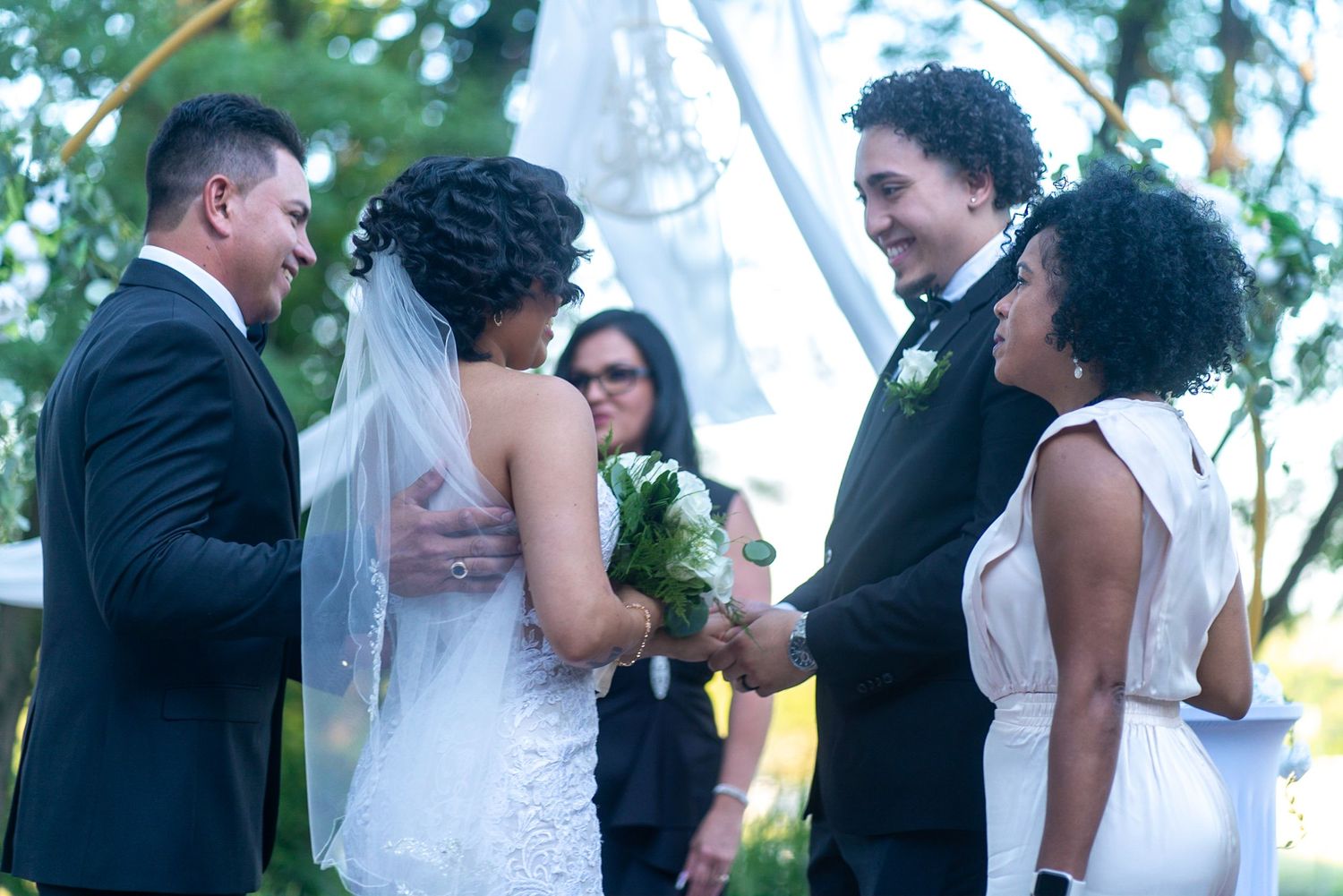 Wedding couple shares candid moments during their outdoor celebration.