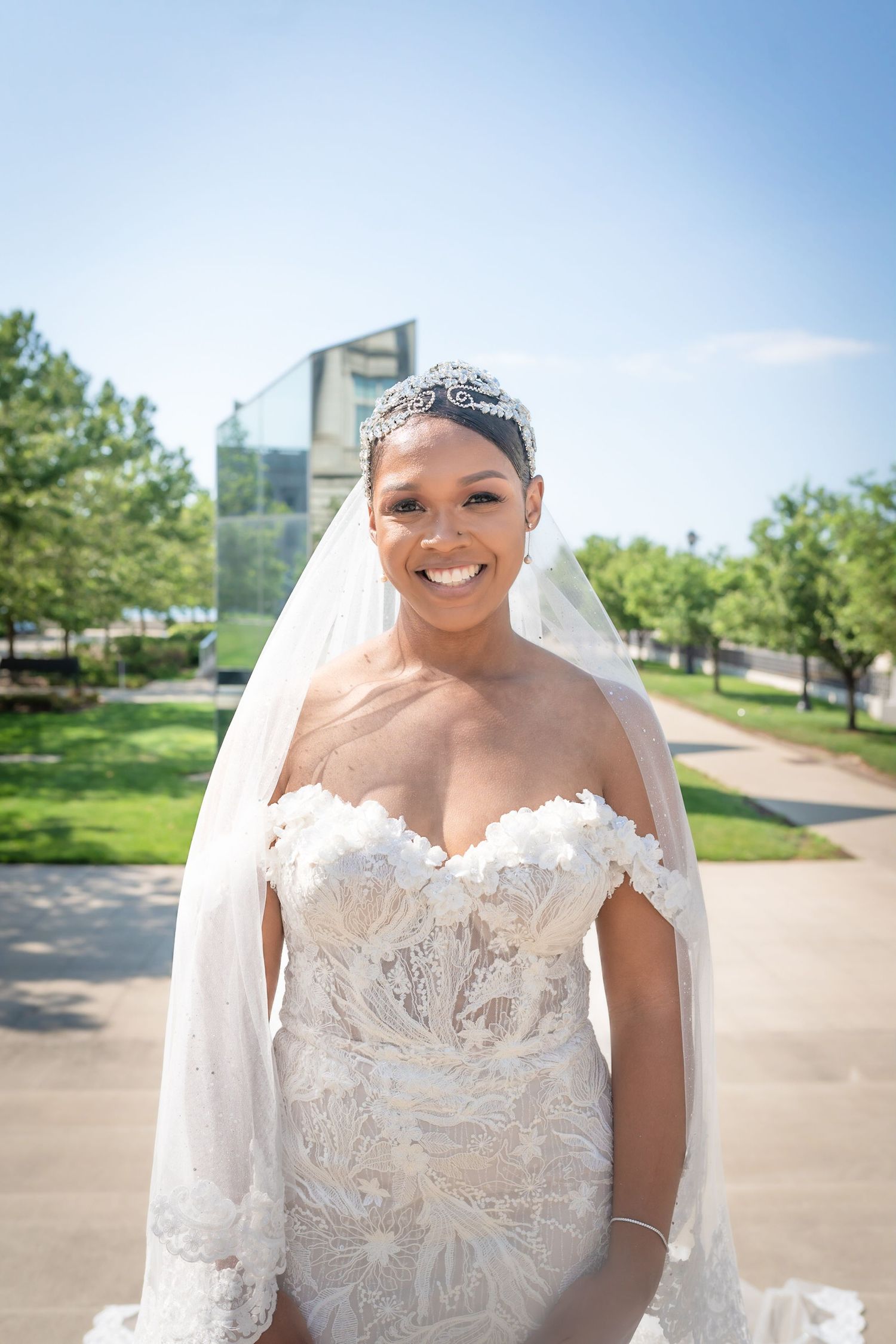 Outdoor bridal portrait with city skyline background and flowing veil.