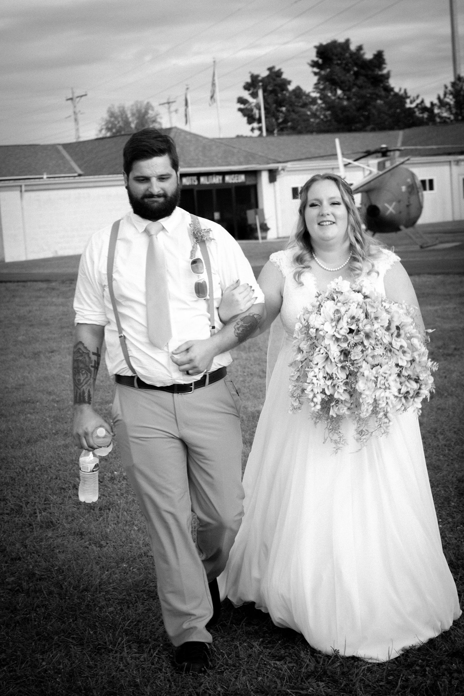 A romantic wedding photo series showing a couple walking together in formal attire on grassy grounds.