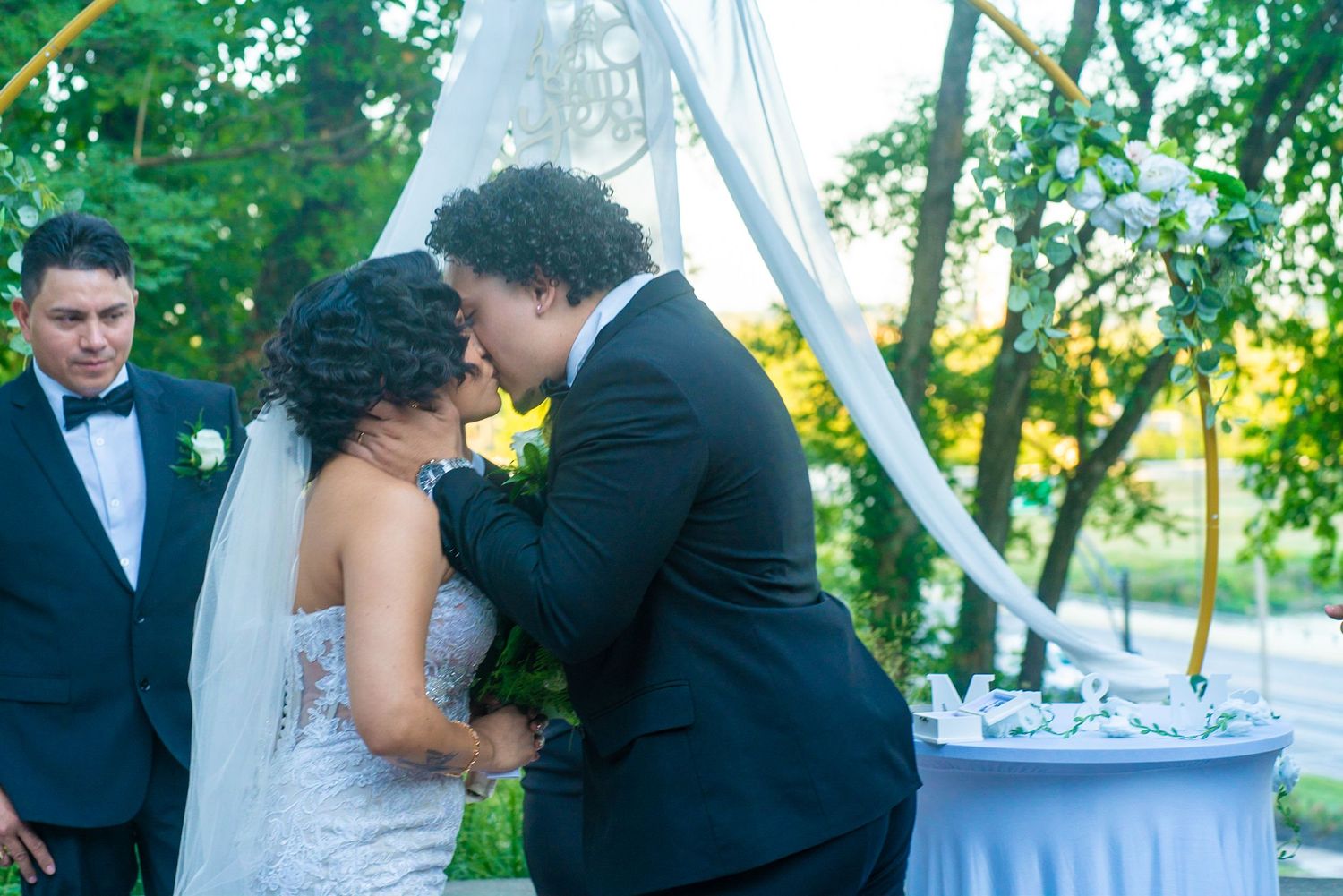 Newlyweds share an intimate moment during their outdoor wedding photoshoot.
