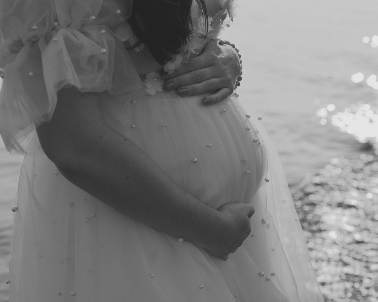 Calm late evening maternity pose by the lake.