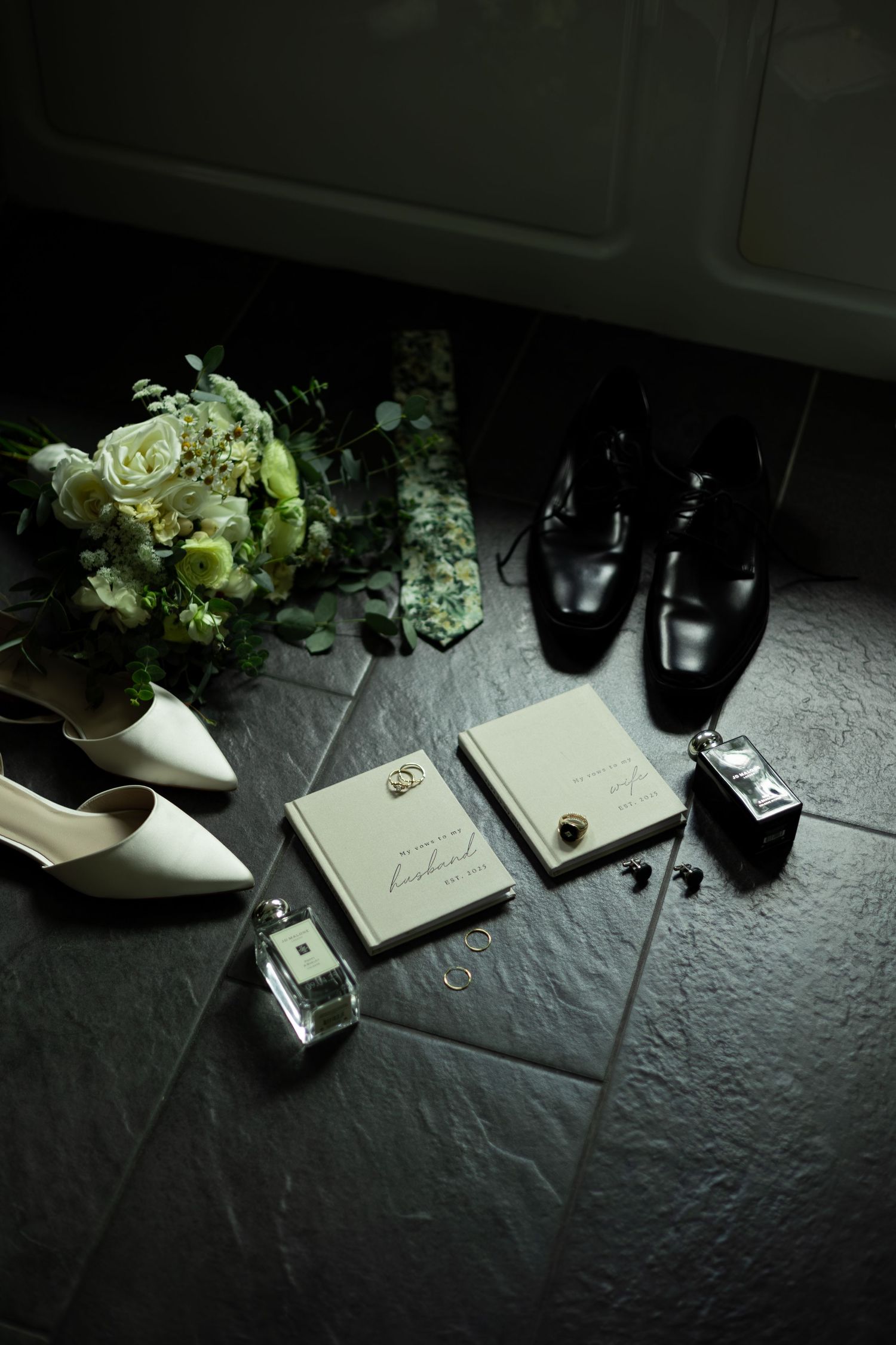 Dramatic black and white photo sequence showing perfume bottle and accessories on textured dark surface with moody lighting.