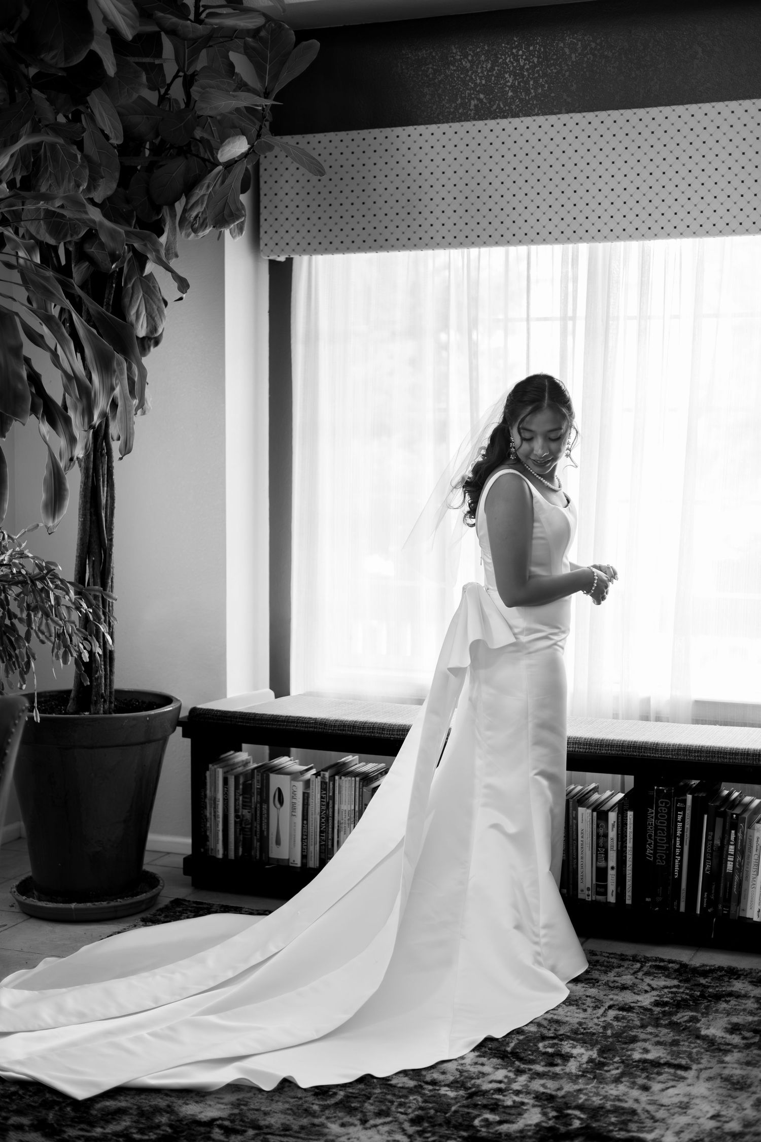 A flowing white wedding dress elegantly displayed in black and white frames showing its movement and dramatic train.