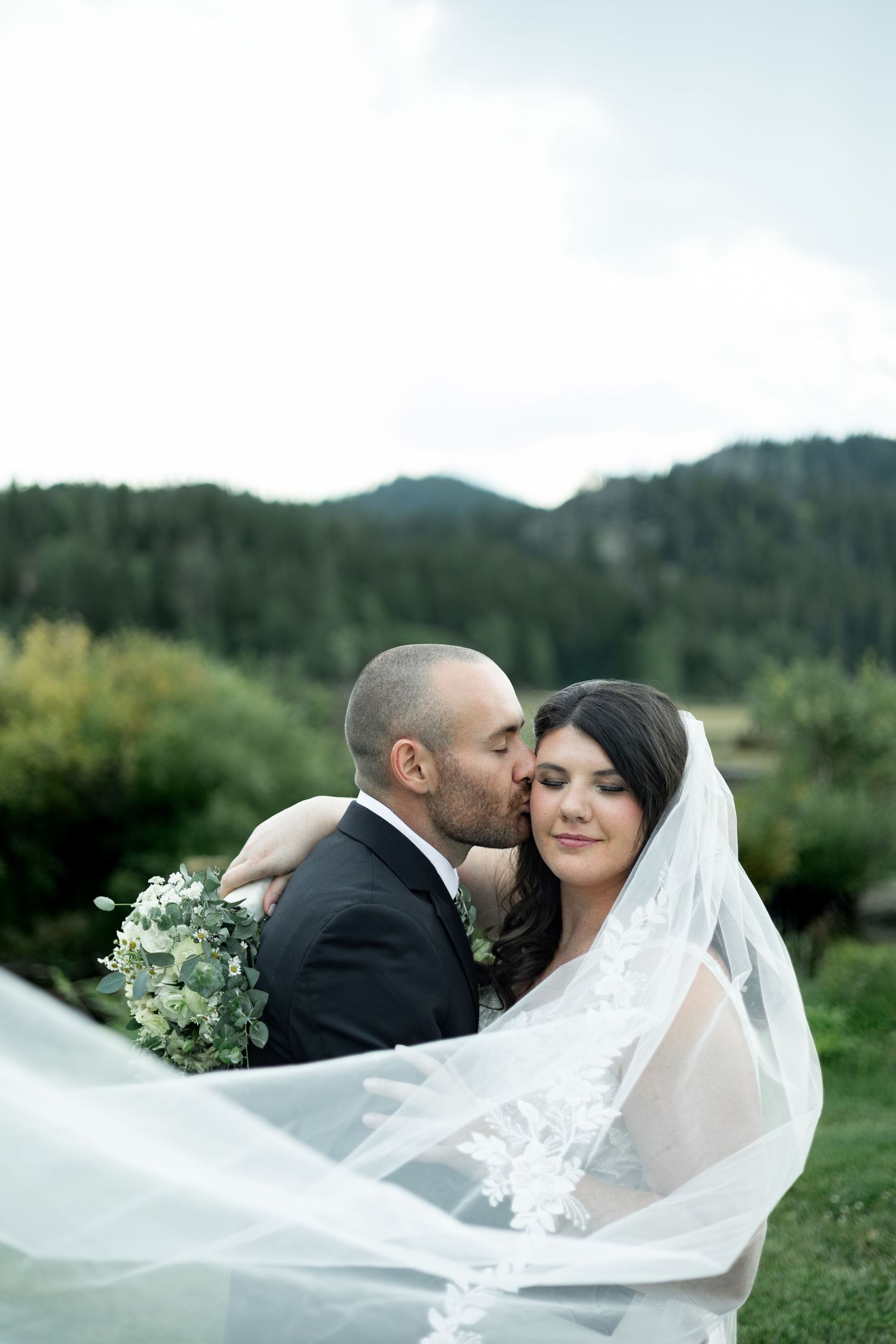 A romantic wedding photo sequence shows a couple embracing outdoors with a flowing white veil against a mountain backdrop.