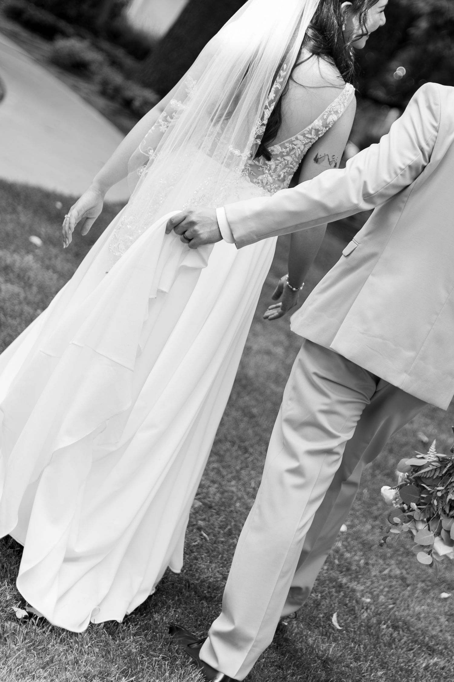 People in flowing white clothing dance and move gracefully in a garden.