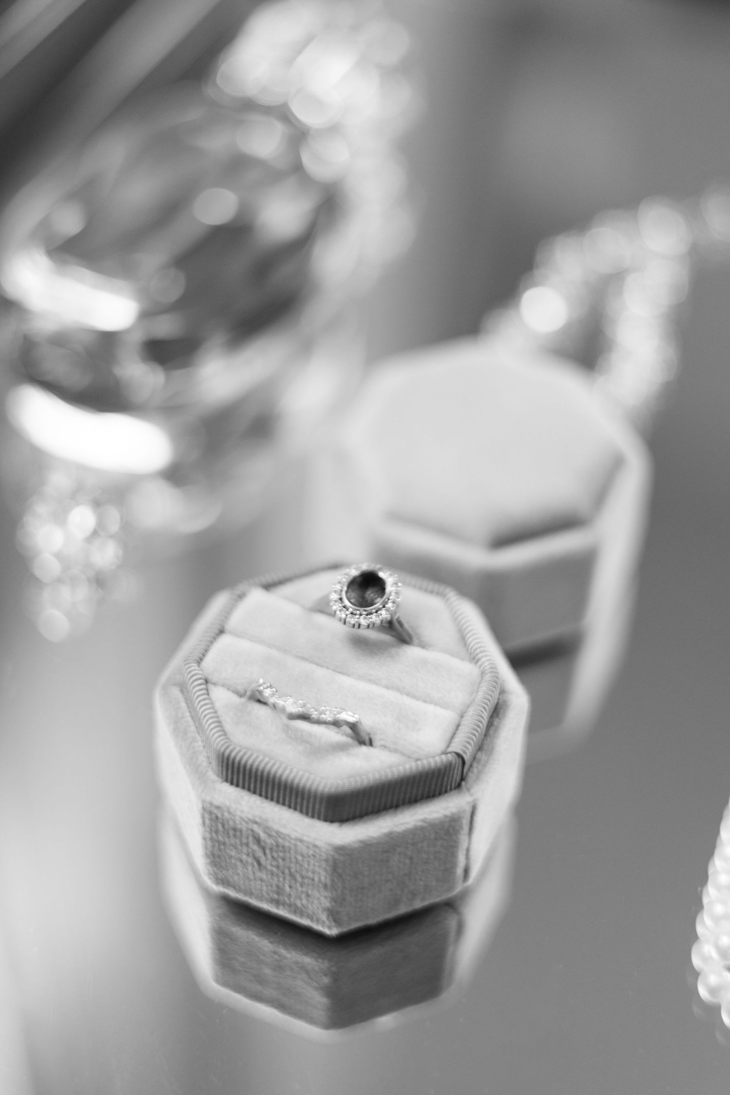 Engagement ring in velvet box with soft focus background.