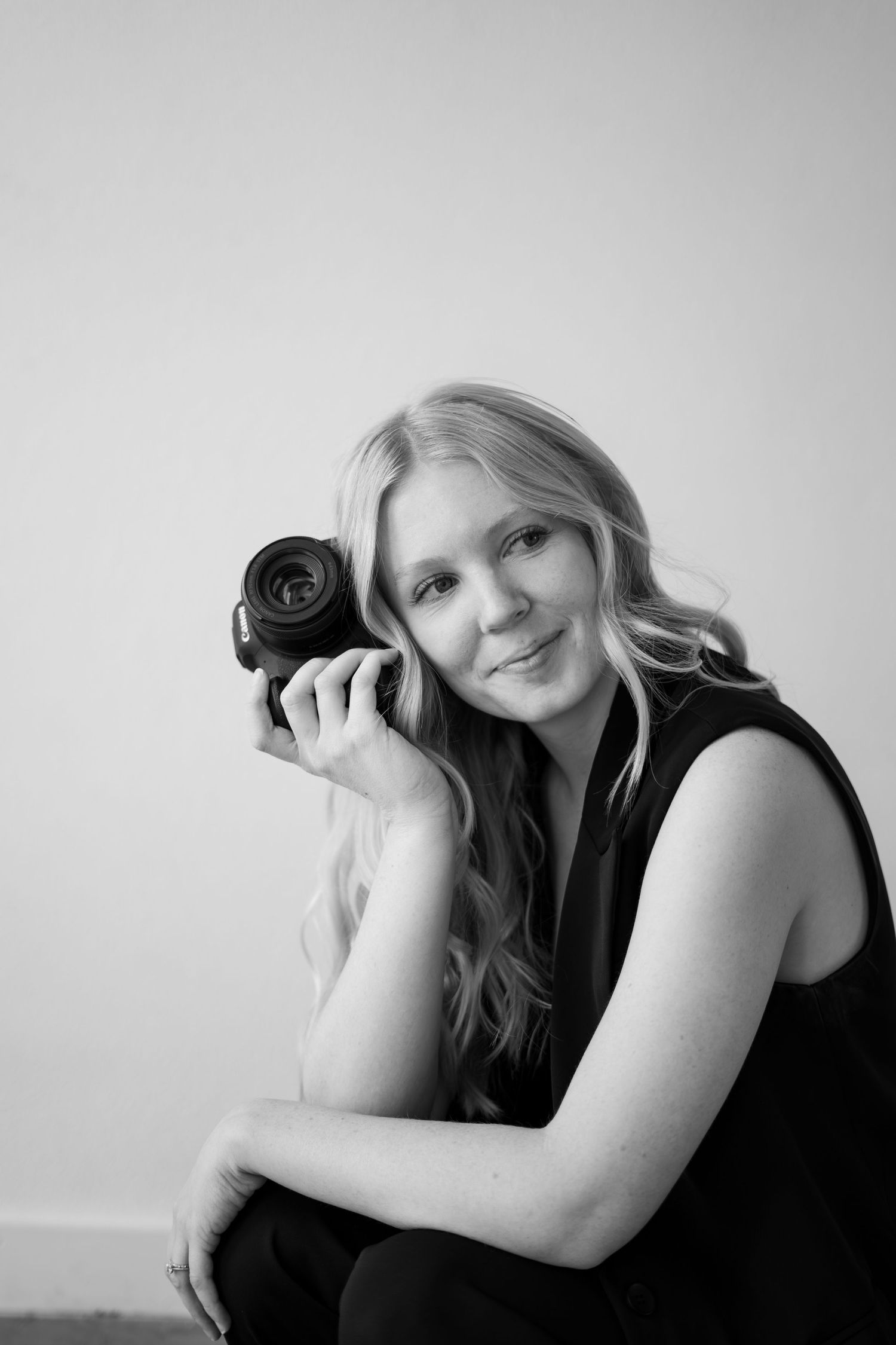 A series of monochrome portrait shots showing someone posing in black clothing against a plain background.