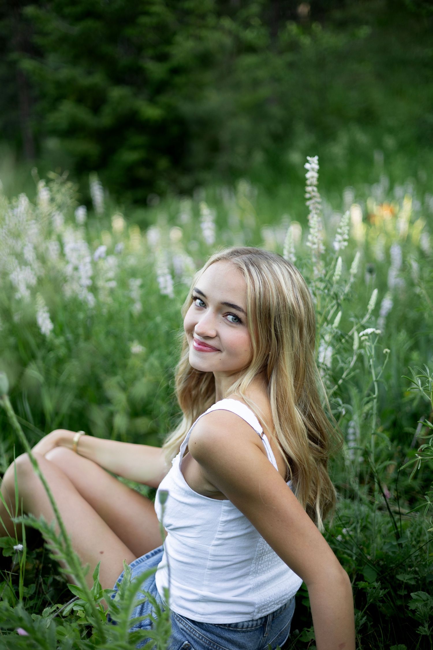 Summer portrait in a wildflower meadow with white flowers and lush green vegetation.