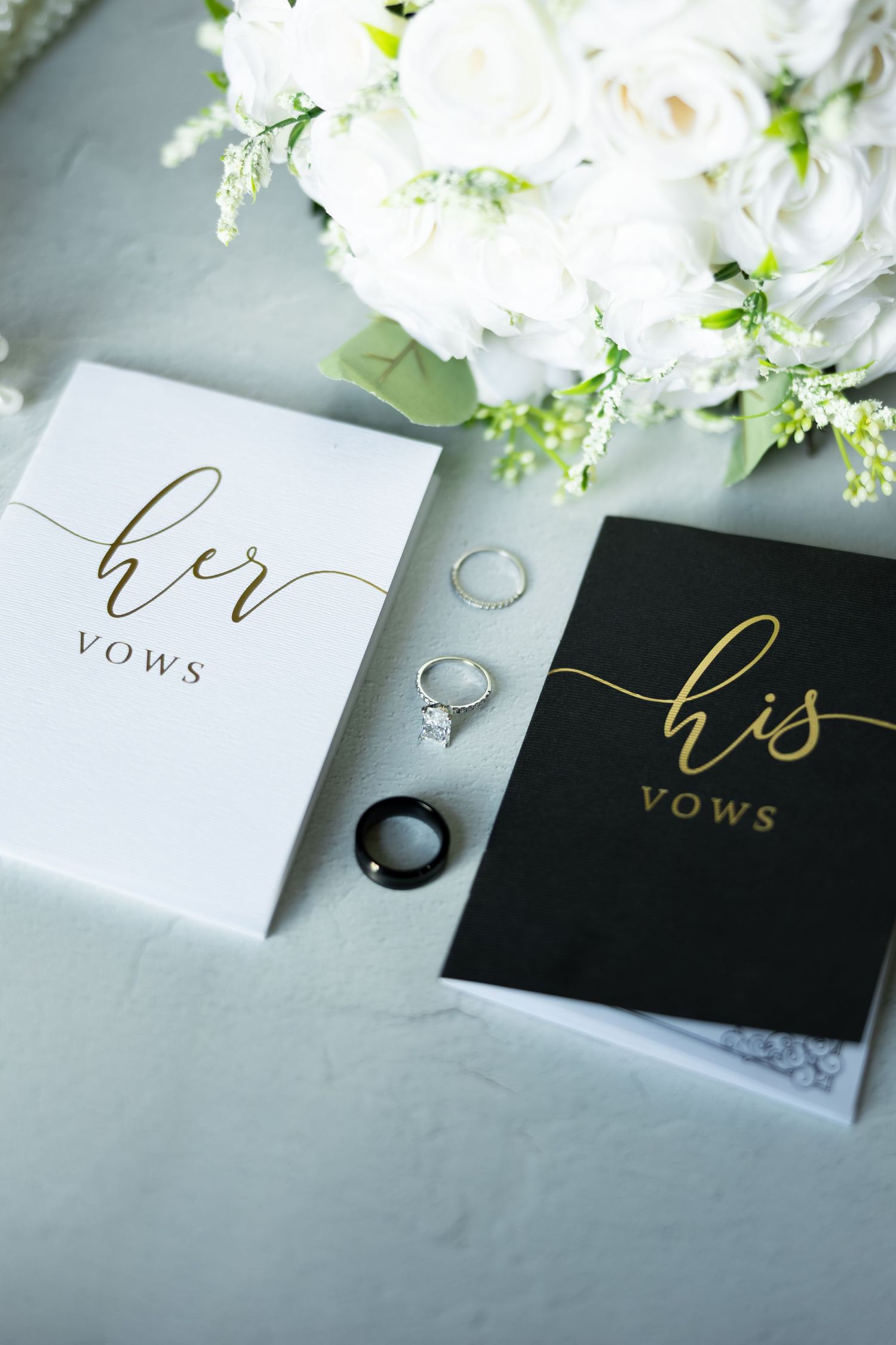 Wedding vow cards in black and white with elegant gold calligraphy and wedding rings.
