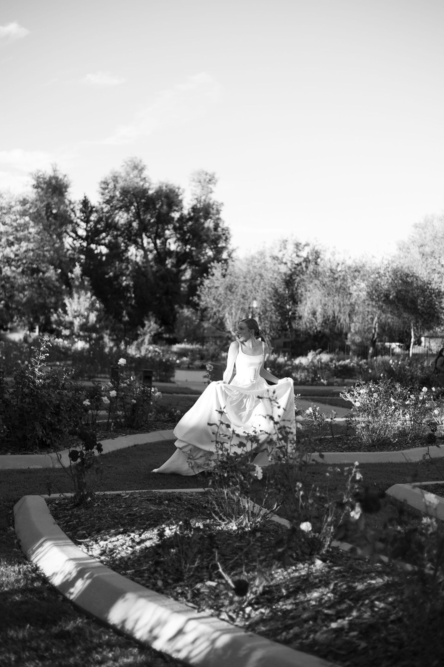 A black and white panoramic sequence showing tents set up in a garden or park-like setting during daytime.