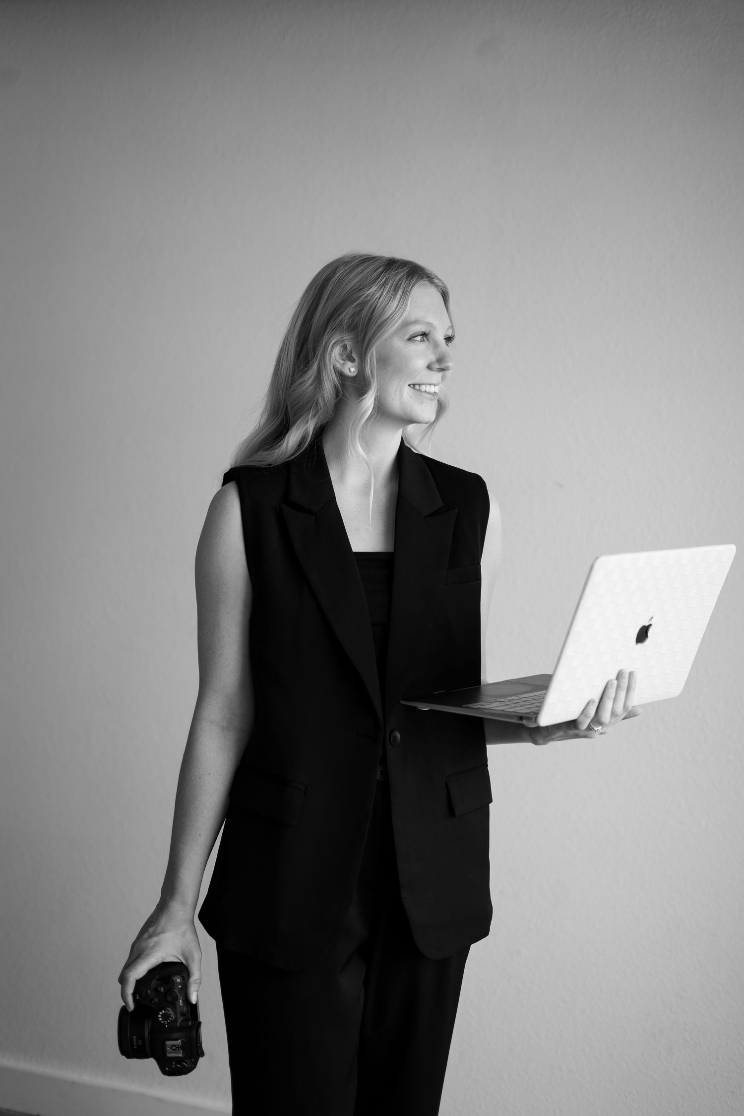 A sequence of black and white photos showing a person in black attire engaging with a bright laptop or device.