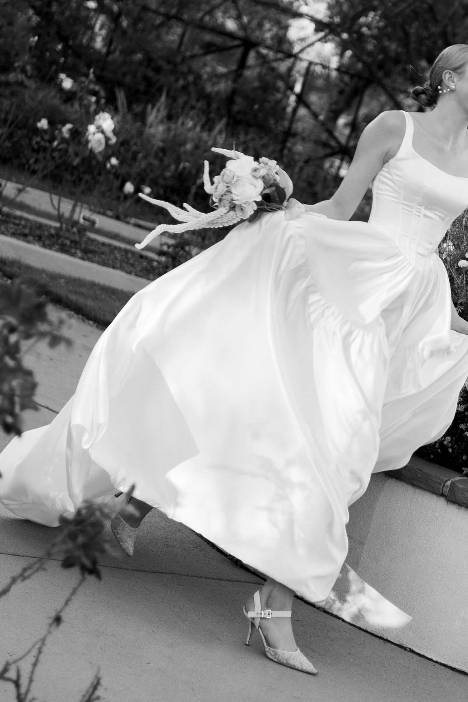A flowing white wedding dress billows dramatically in the wind across a series of black and white photographs.