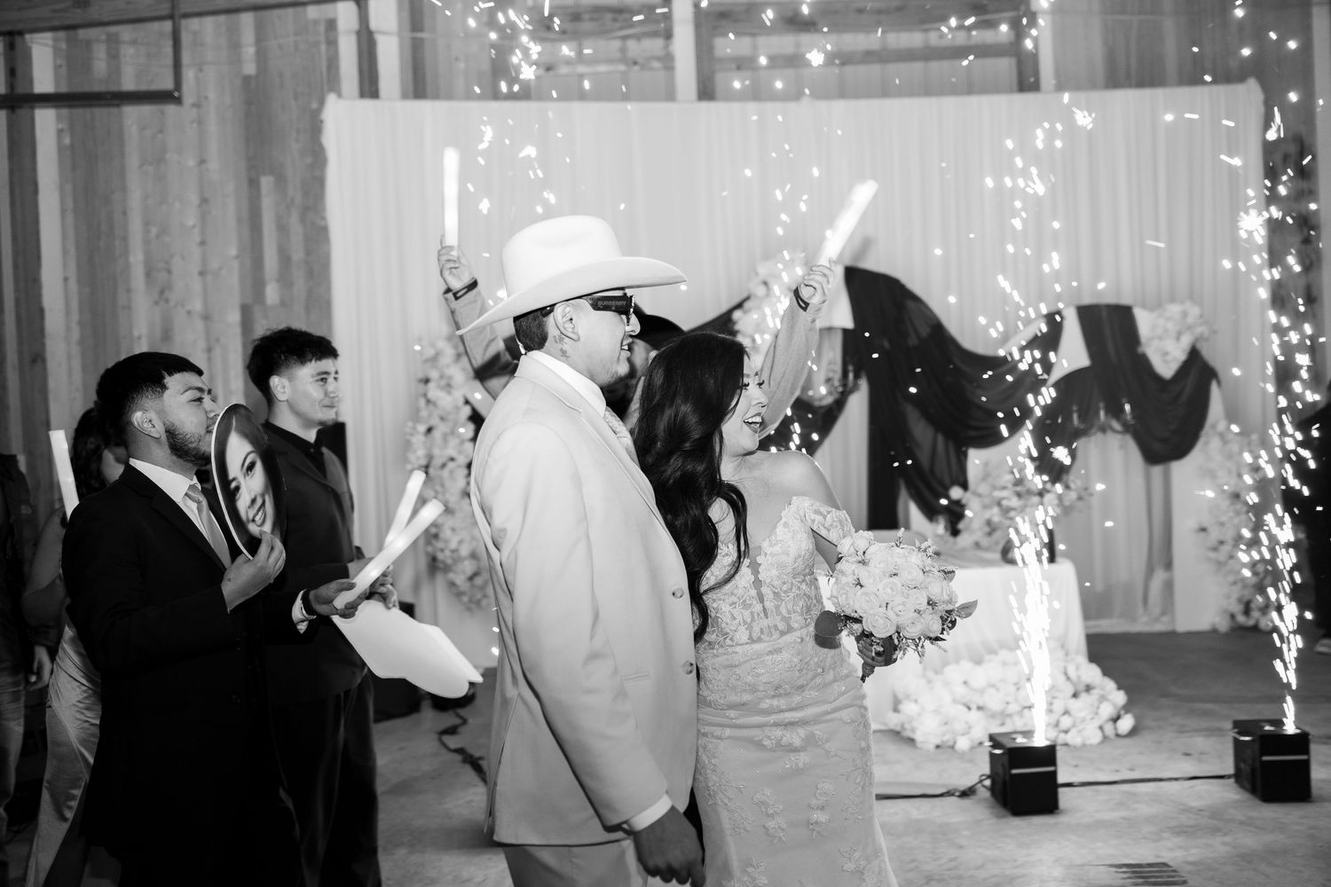 Wedding reception dance floor with string lights and dancing guests in formal attire.