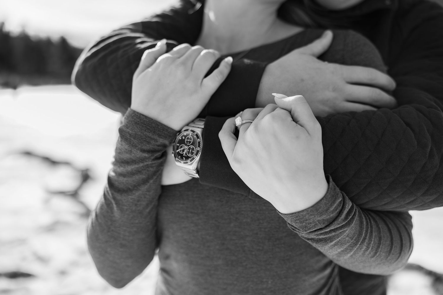 Black and white photo series showing hands holding and interacting with a vintage camera from different angles.