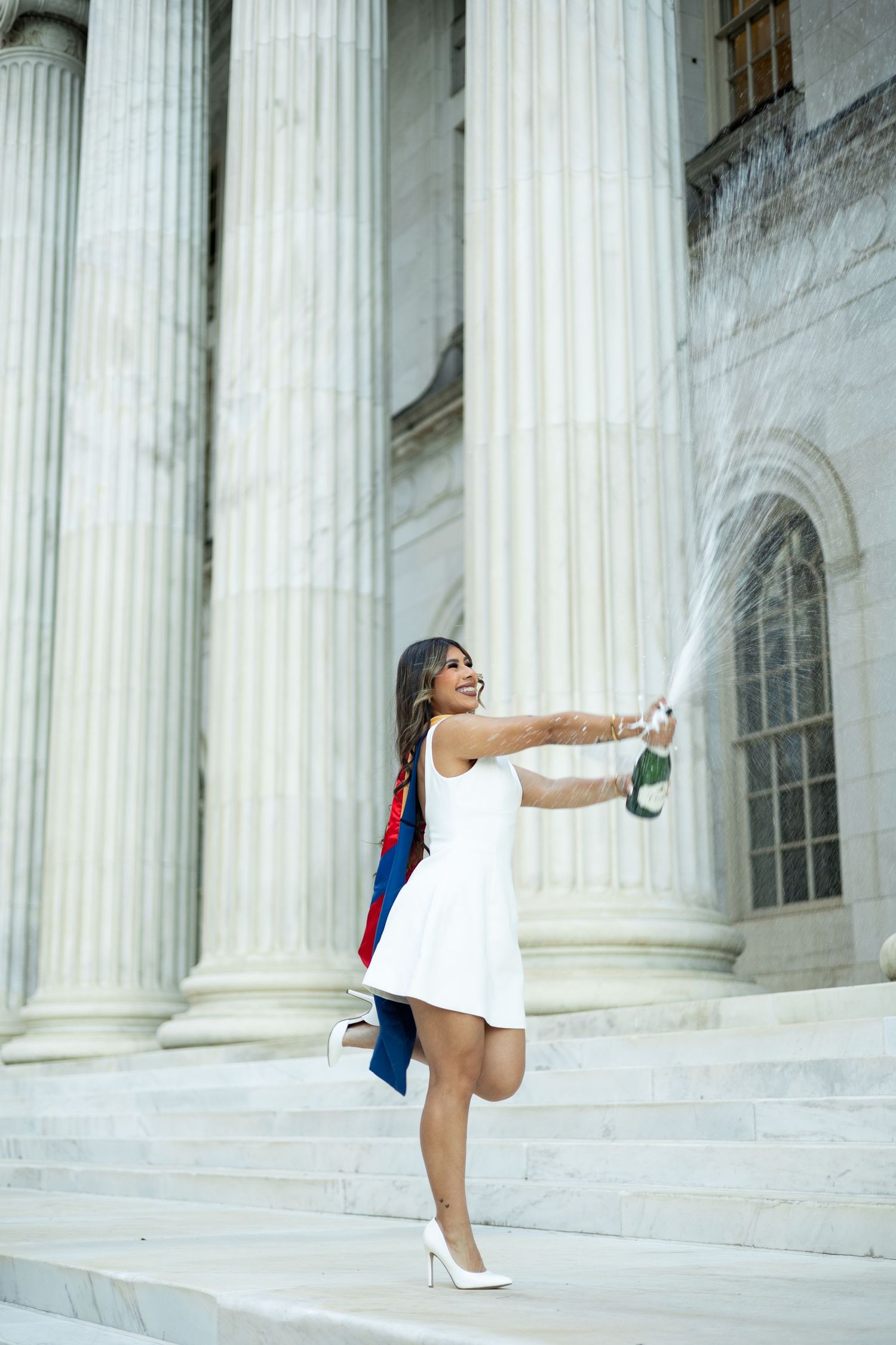 A dancer strikes graceful poses against white marble columns in a series of connected artistic photographs.