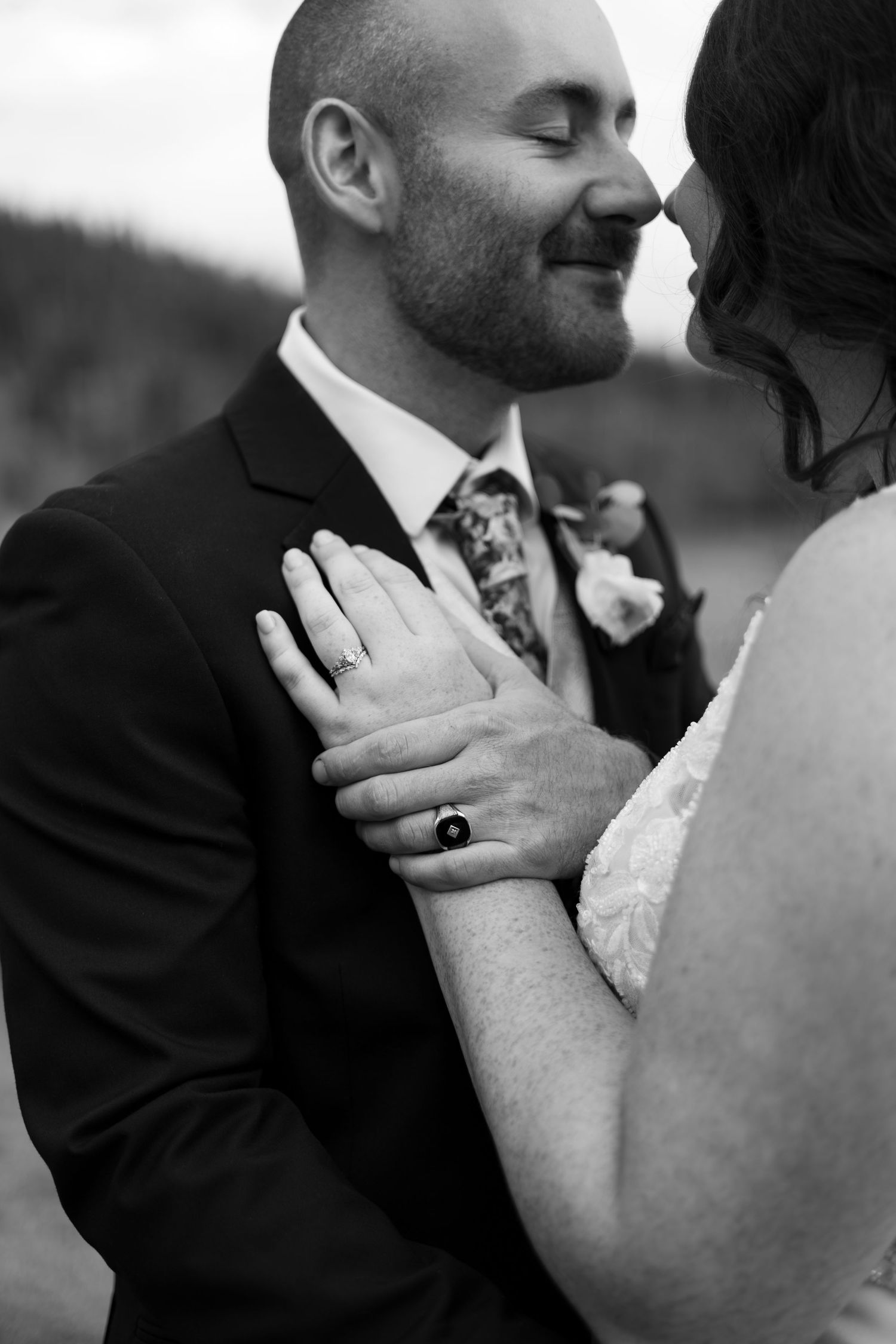 A series of intimate black and white wedding photos showing tender moments between newlyweds.