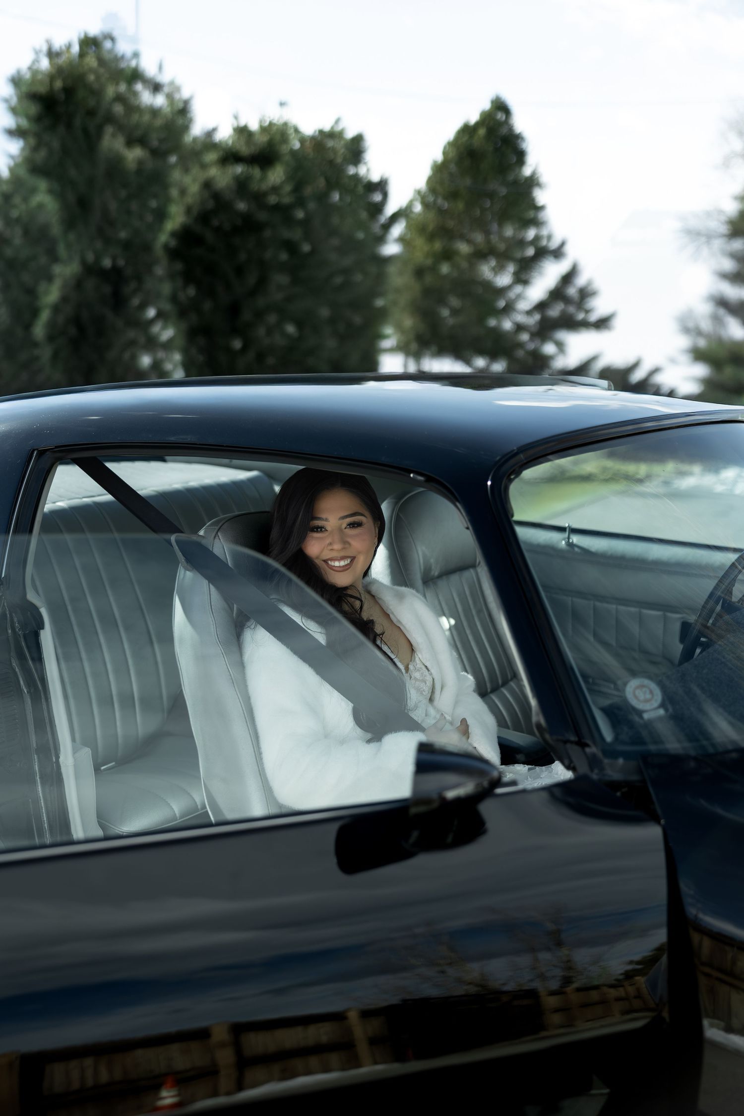 Wedding transportation sequence showing luxury car with passengers through window frames.