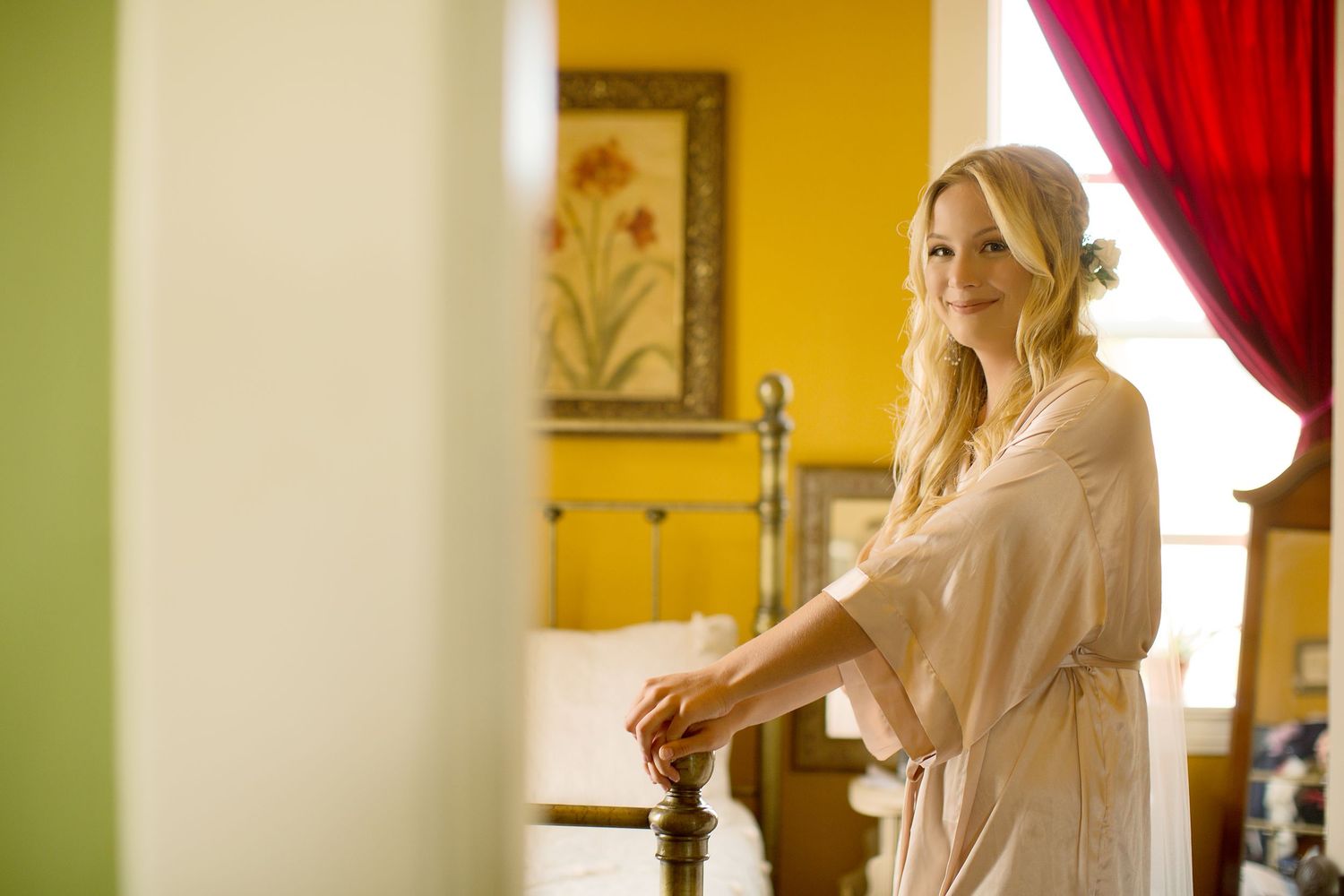 Sunlit wedding preparations through windows with flowing curtains creating a dreamy atmosphere.