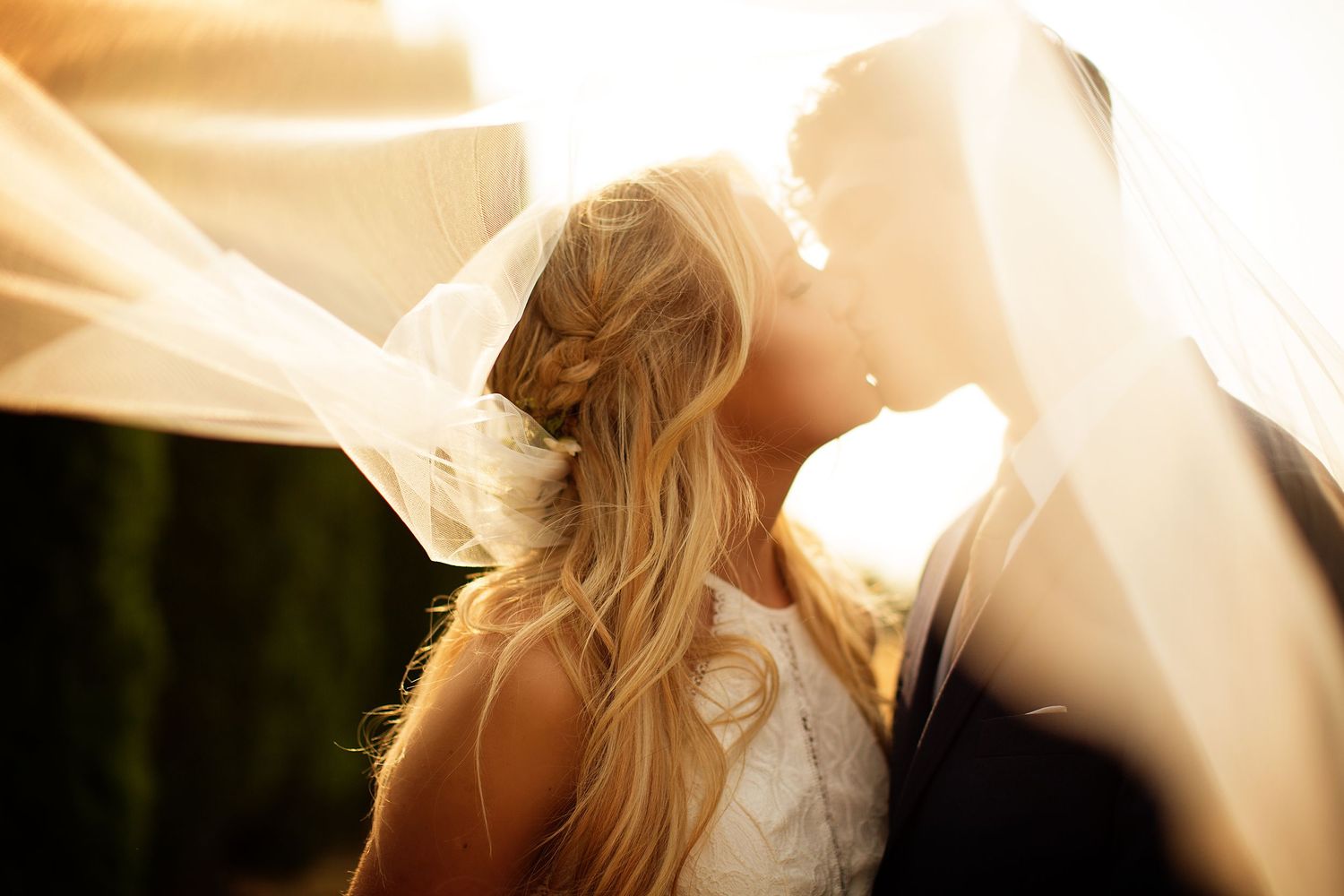 A romantic sunset engagement photo session with a couple embracing in golden light.