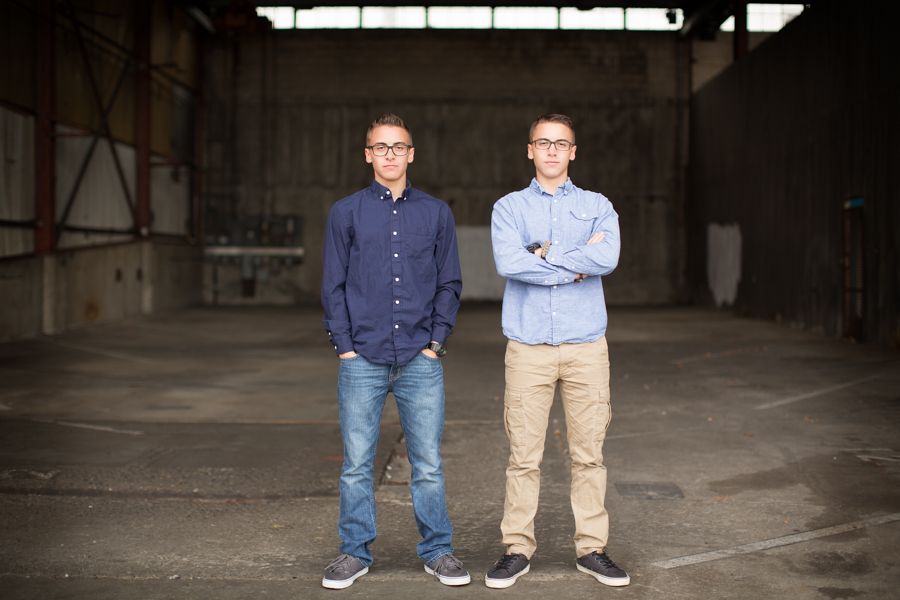 Group portraits in industrial warehouse setting with dramatic lighting.