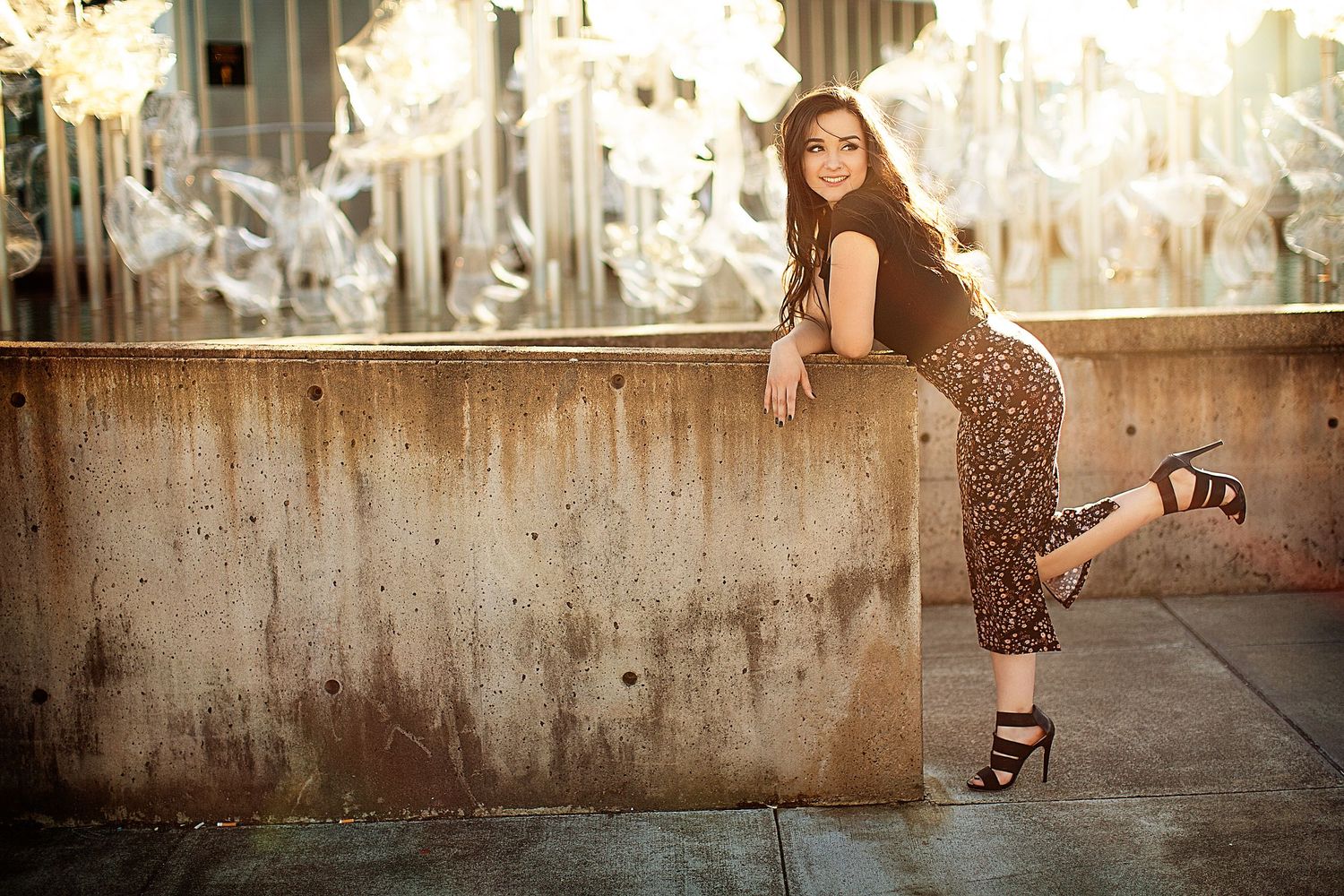 Stylish portrait session against an industrial concrete wall backdrop.
