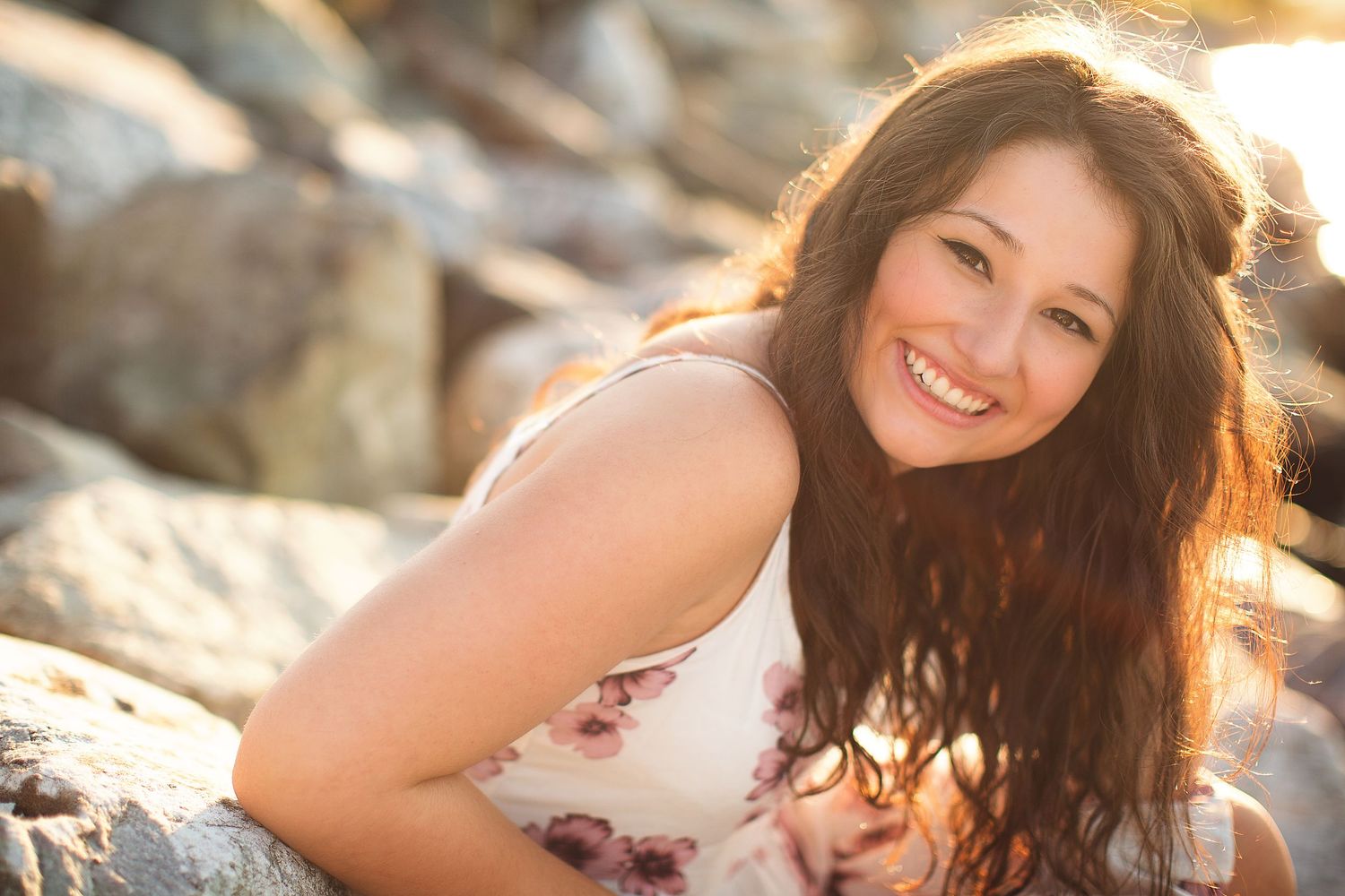 Candid portraits captured at sunset with warm golden lighting and natural smiles.