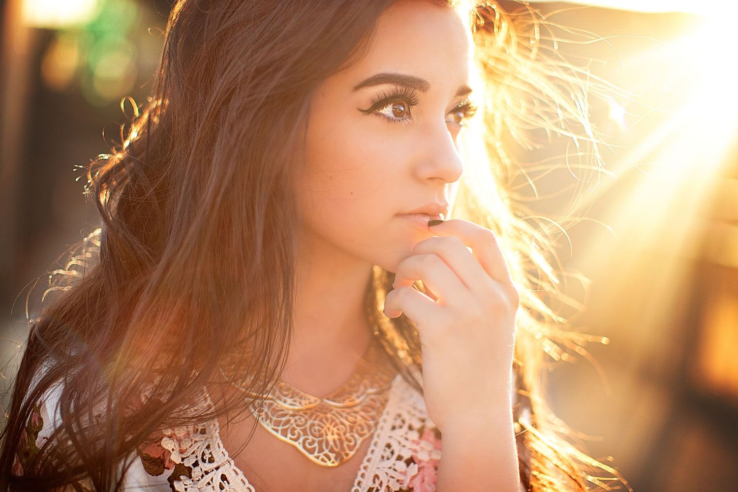Golden hour portrait session with flowing hair and delicate lace details.