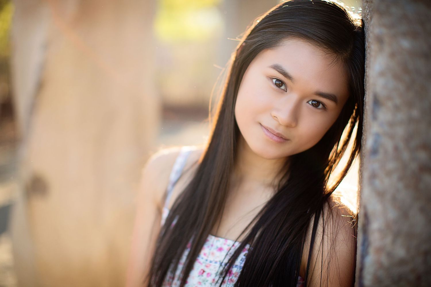 Portrait series with soft natural lighting against a blurred outdoor background.