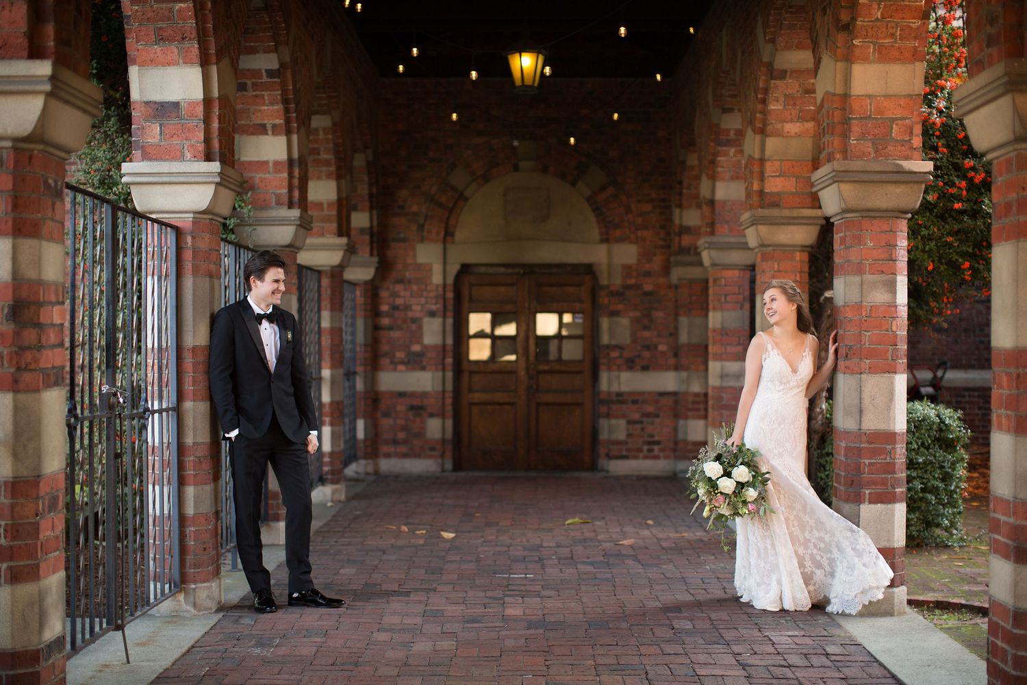Wedding photography session along brick walkways and archways.