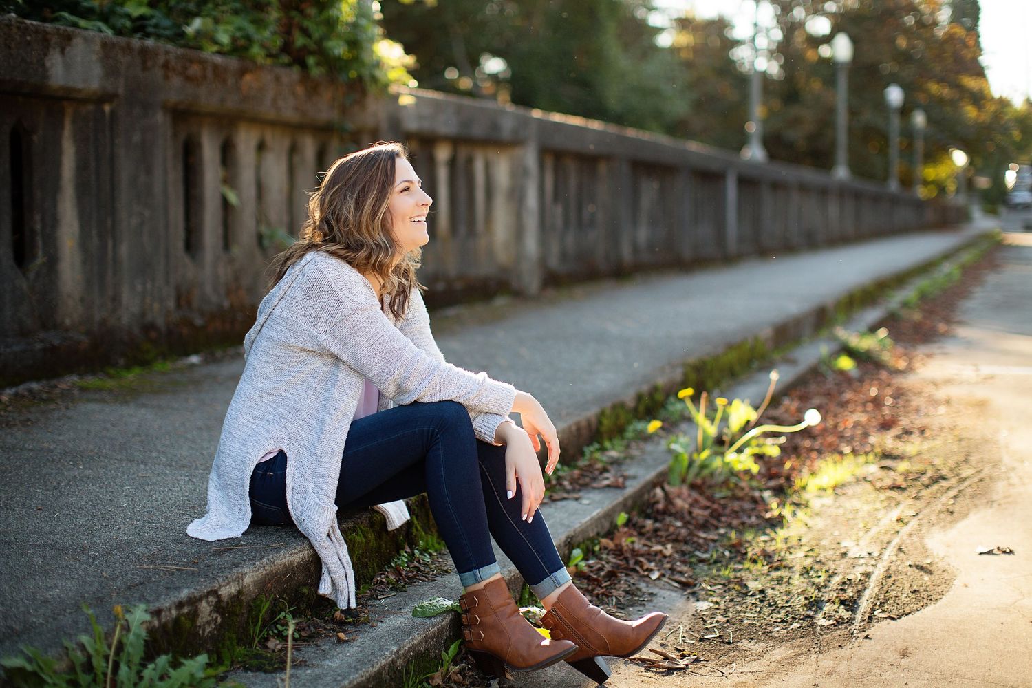 Casual outdoor portrait session along rustic fence at sunset.