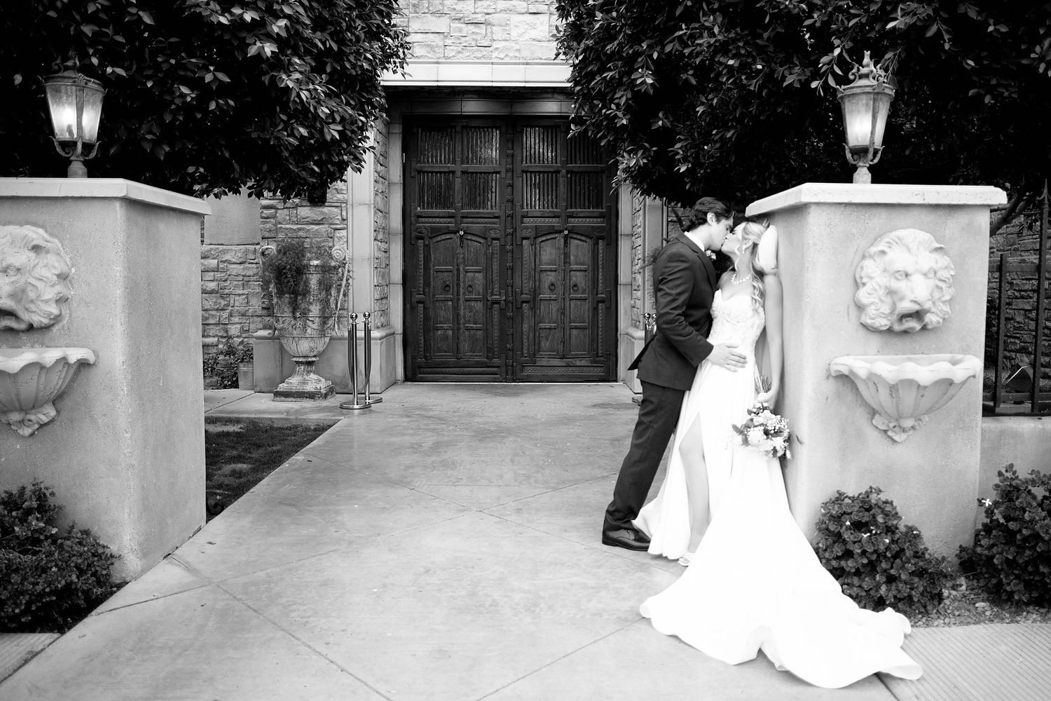 Black and white sequence of a couple posing in front of an elegant building entrance.