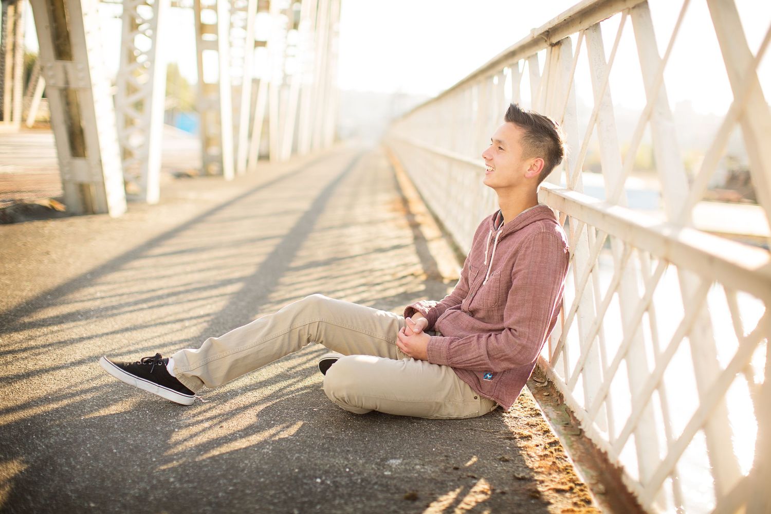 Lifestyle photos taken on a wooden bridge with dramatic shadows and sunlight.