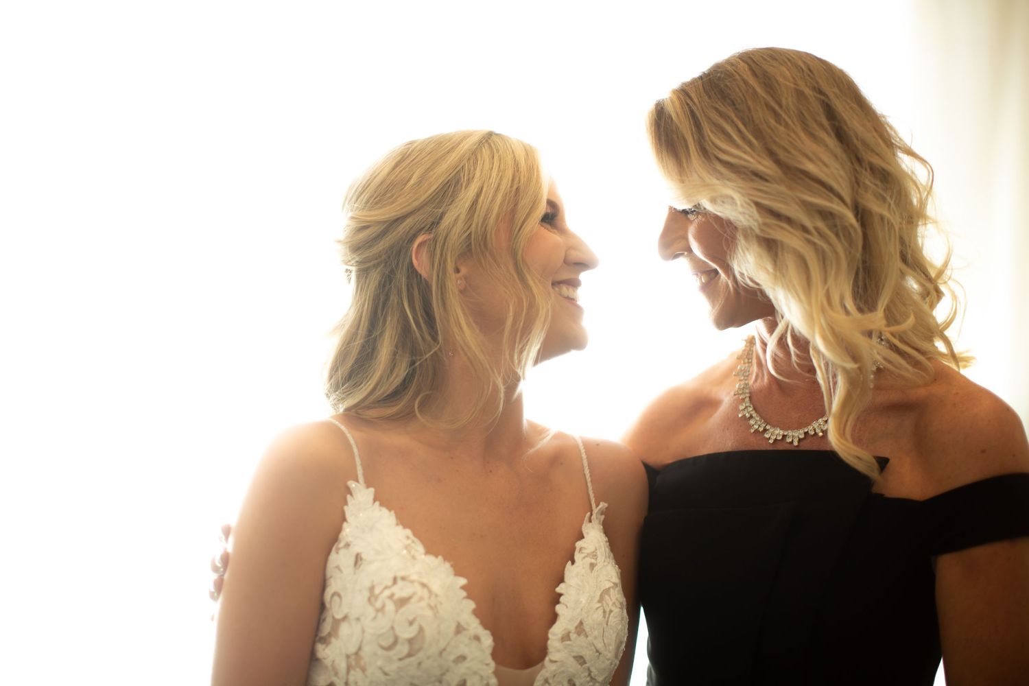 Natural light illuminates intimate wedding preparation moments.