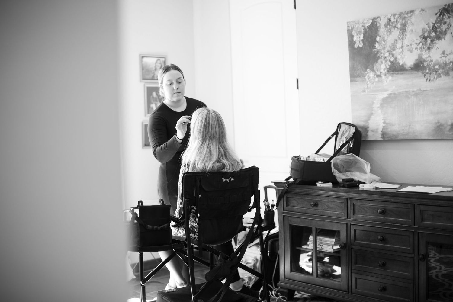 Black and white behind-the-scenes photography session in a minimalist studio.