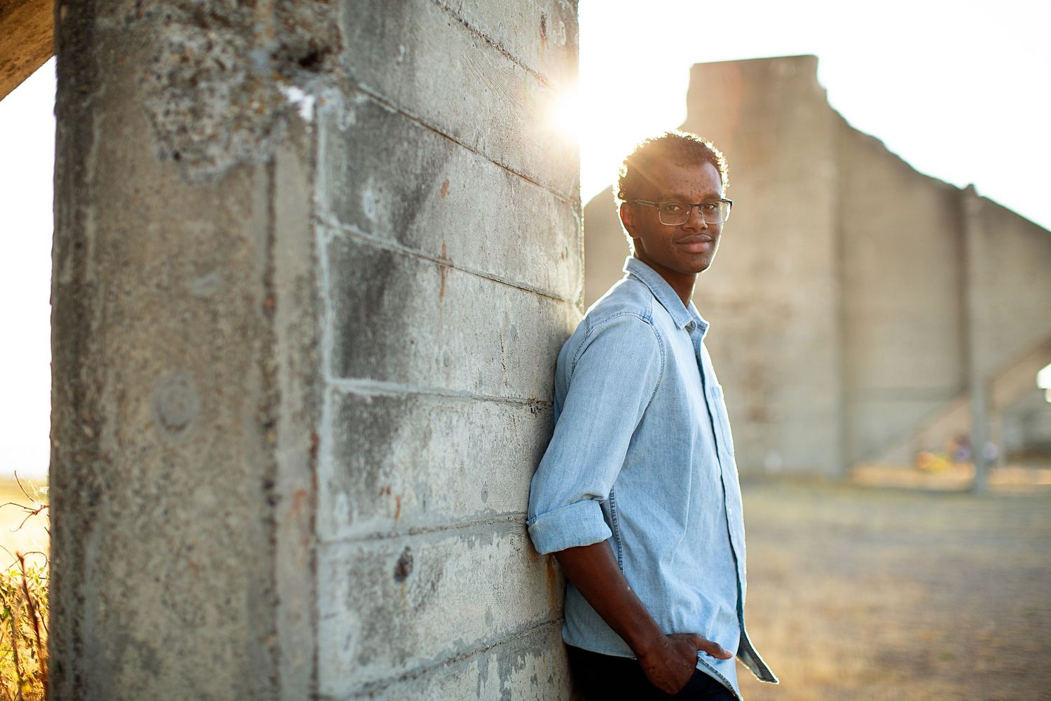 Professional portraits against stone walls in warm evening light.