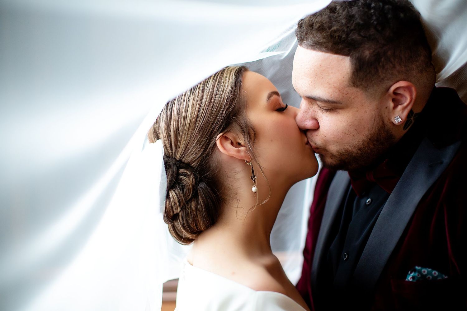 A romantic moment shared between a couple in formal wedding attire.