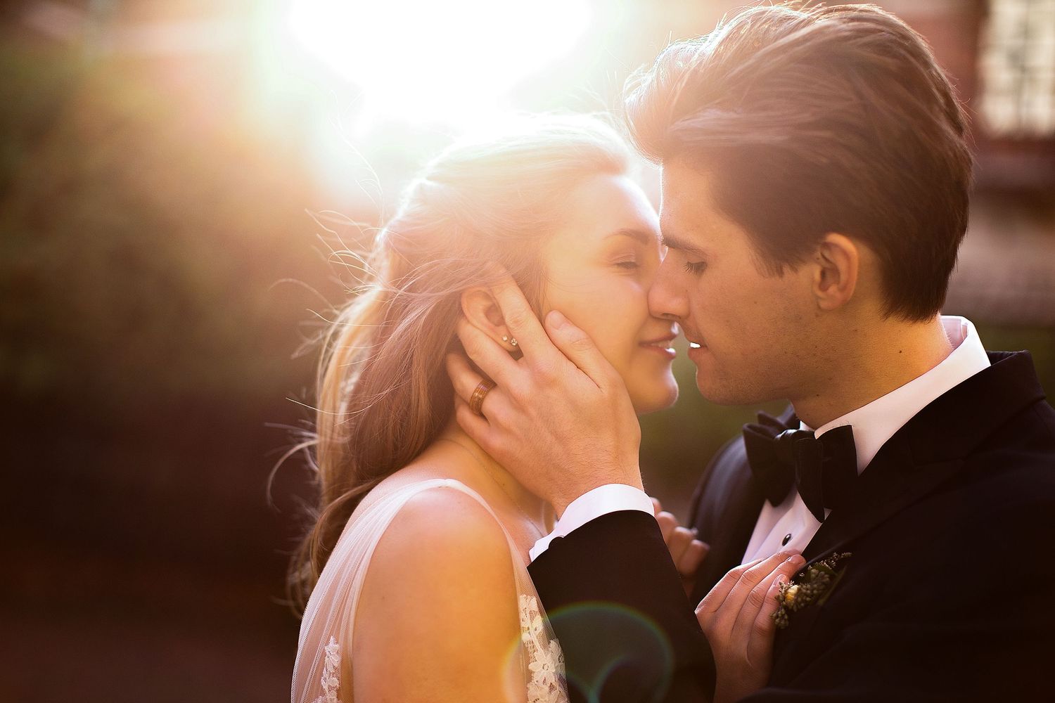 Intimate wedding couple portraits with golden sunlight streaming through.