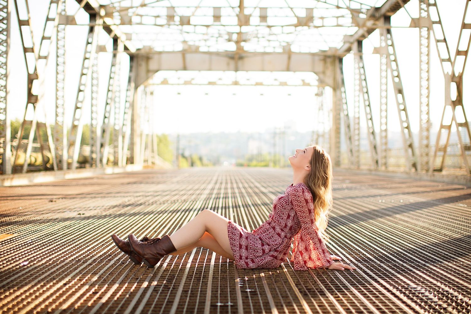 Artistic portraits on an industrial metal bridge with geometric patterns.